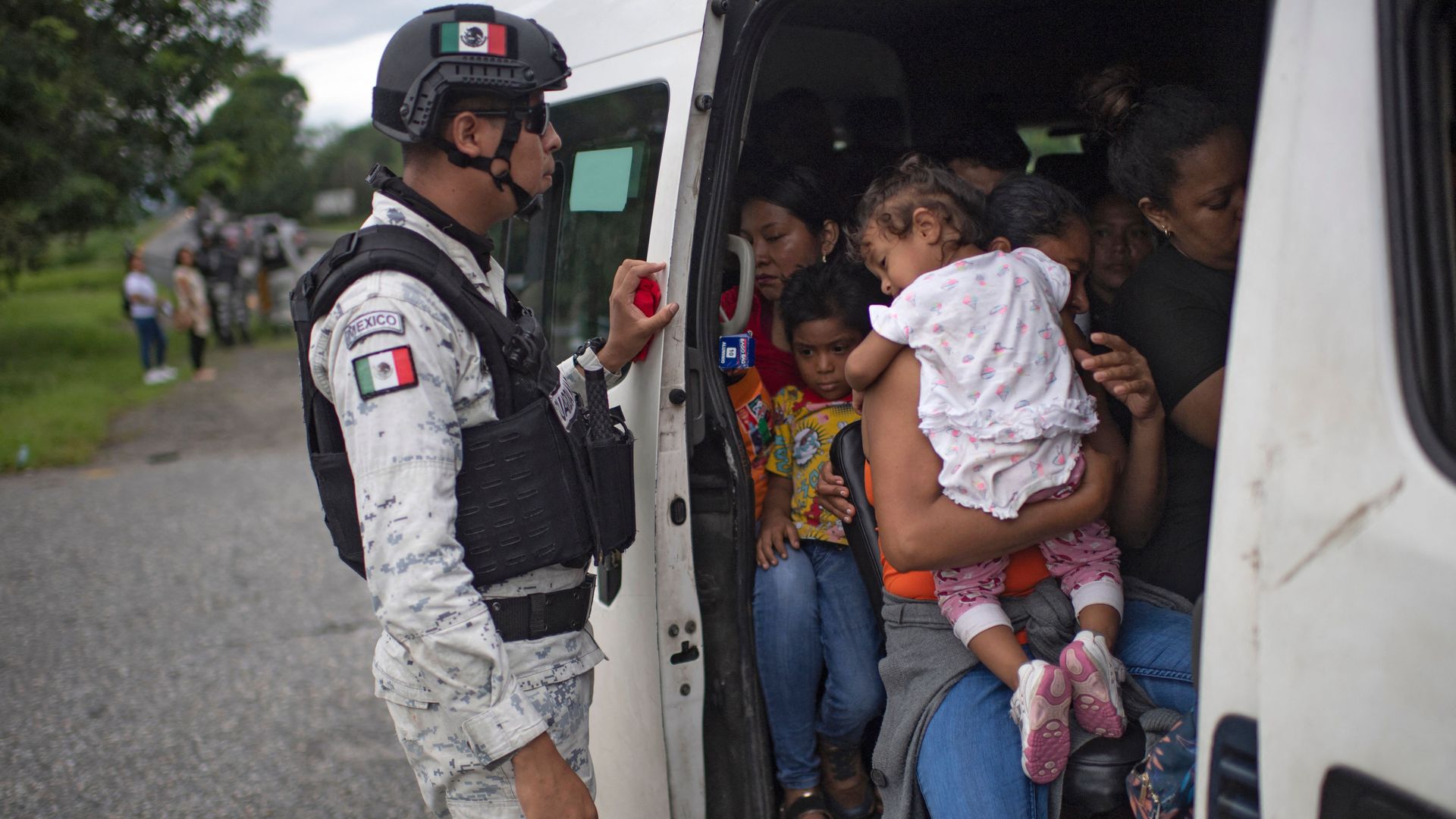 Members of Mexico's National Guard stop a public transport van to ask passengers for documents and find migrants taking part in a caravan heading to the US.