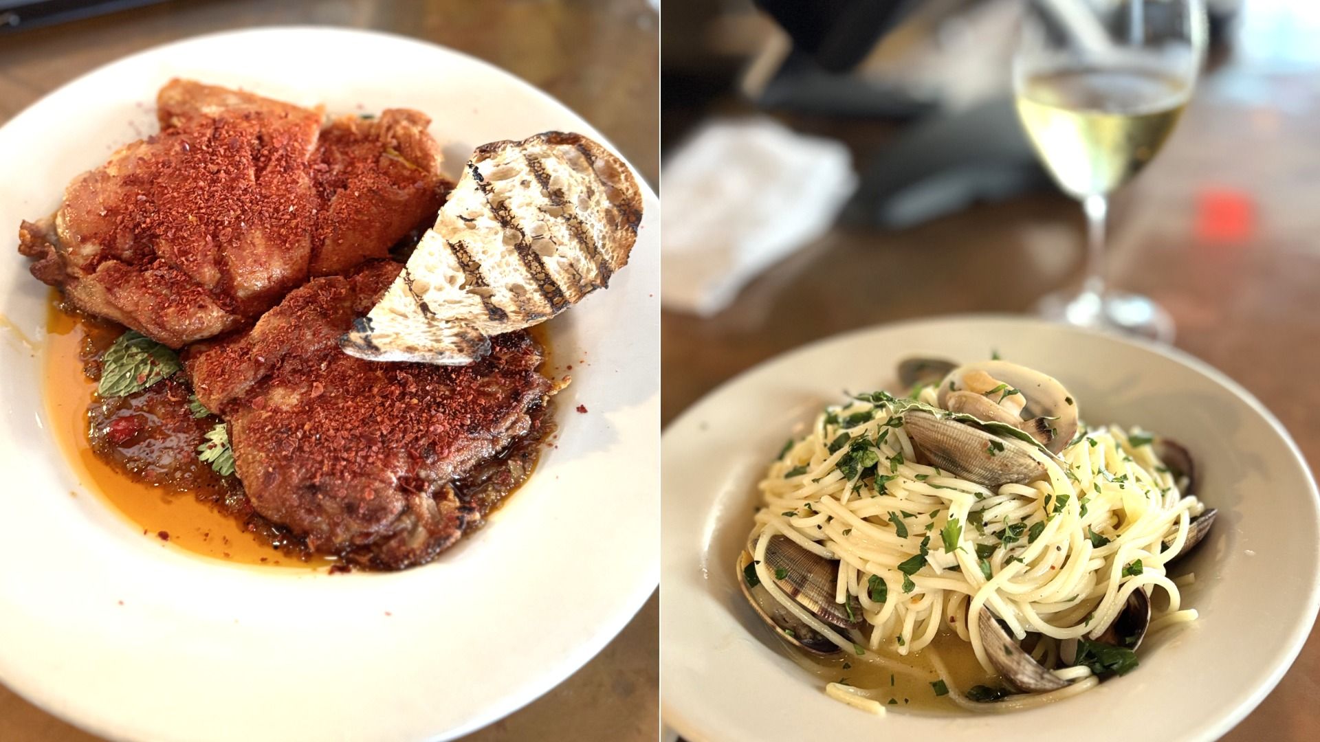 Two plates of food: one with seasoned fried meat topped with red spices and grilled bread, the other with spaghetti and clams garnished with parsley, next to a glass of white wine.