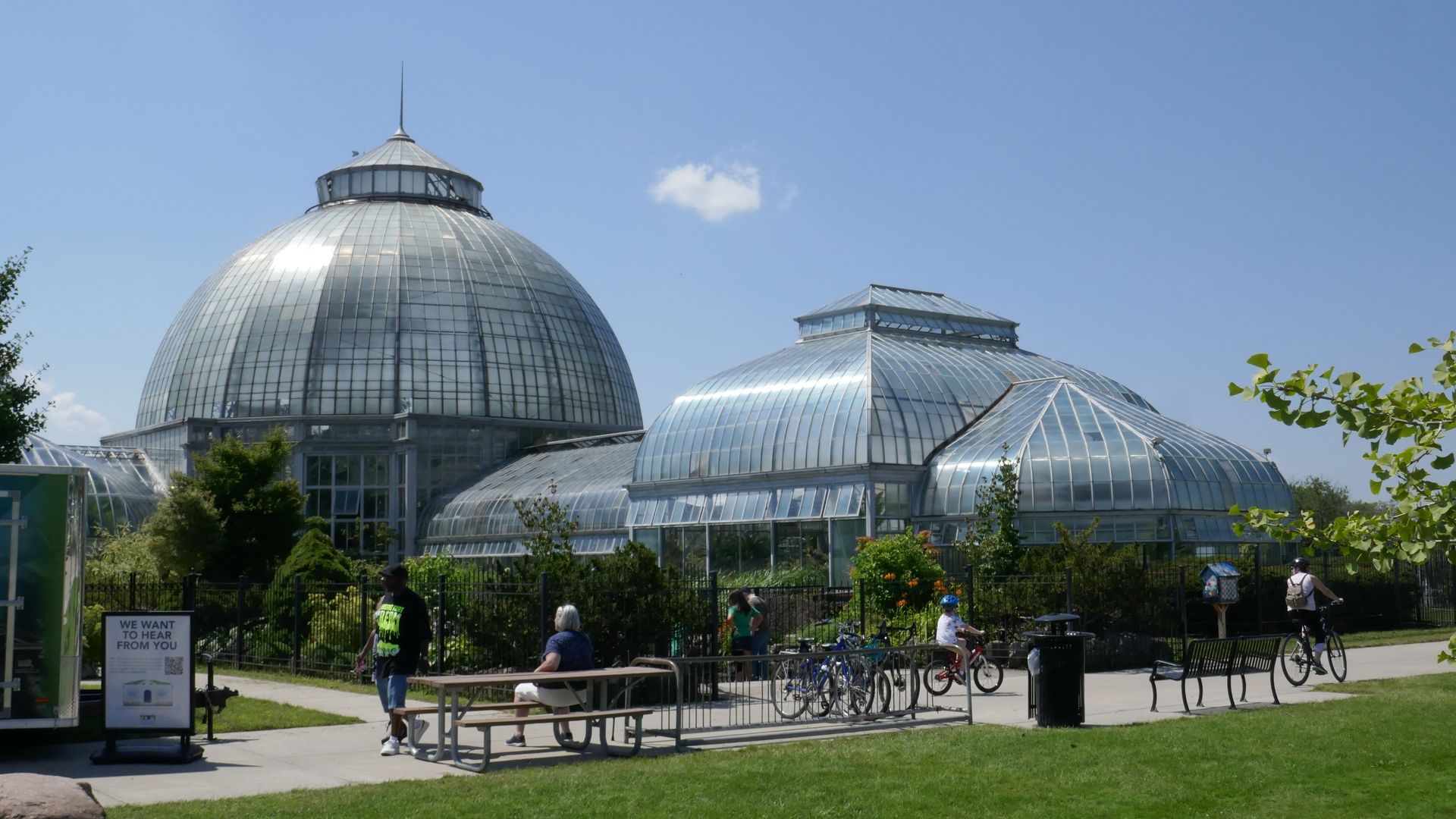 The conservatory is shown with its large glass dome, and picnic tables in front.