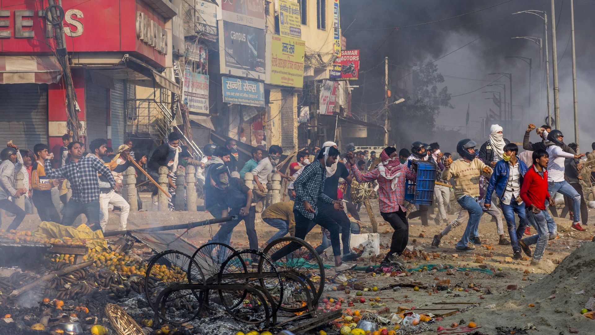 Protesters opposing a new citizenship law throw bricks and stones at those who are opposing the law in Delhi, India.