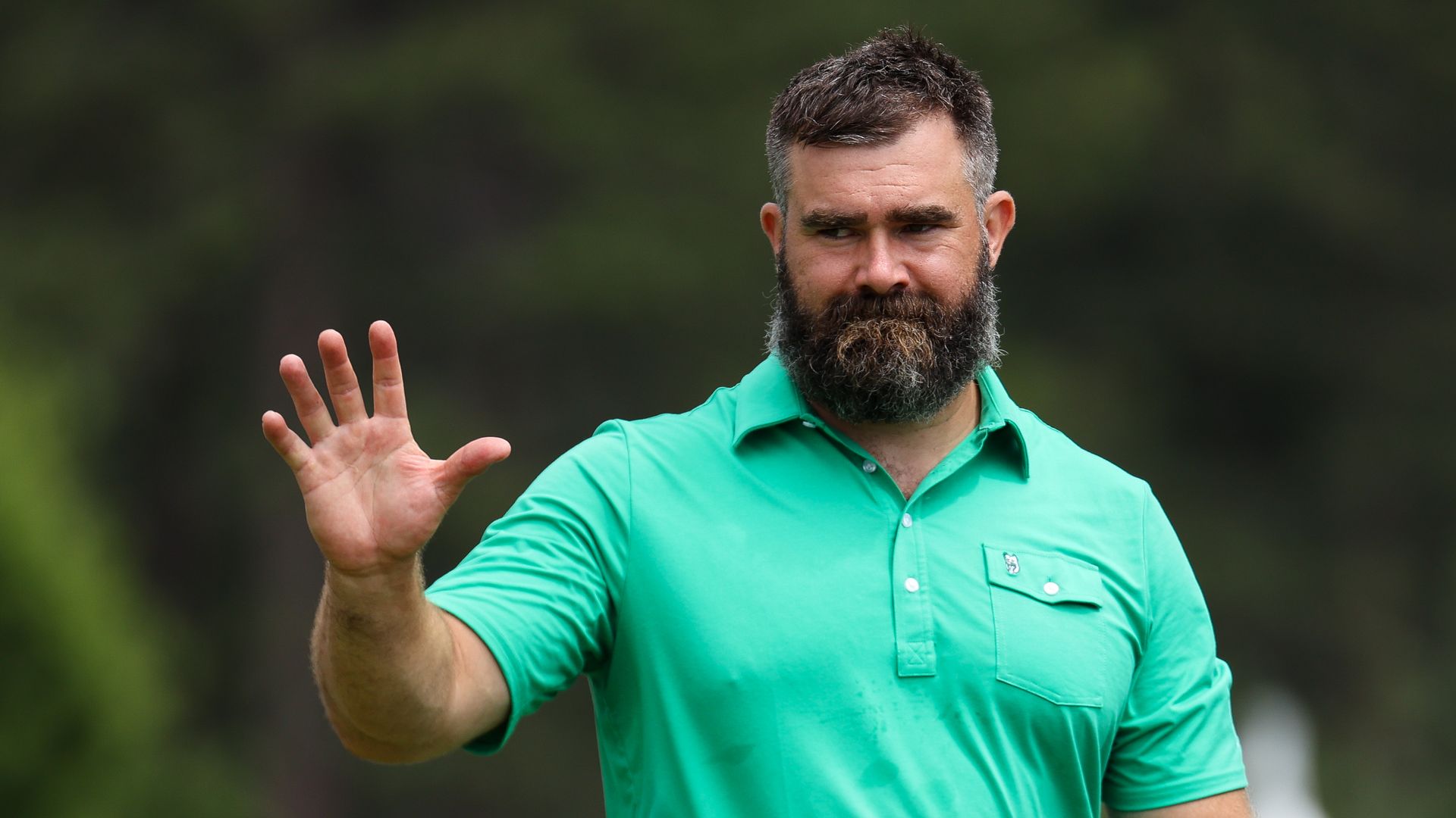 Former NFL football player Jason Kelce waves to fans at the 2024 American Century Championship.