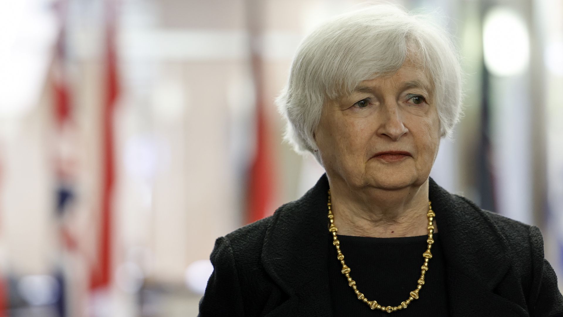 Janet Yellen, wearing a black suit and a gold necklace.