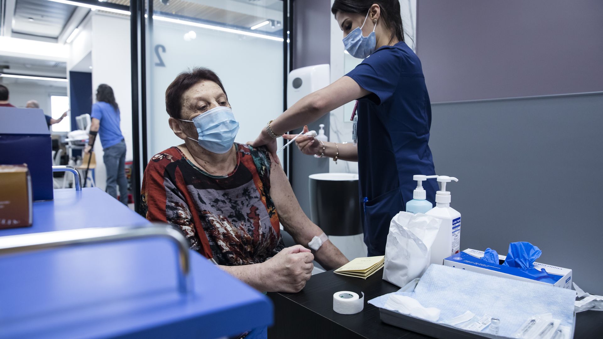 Picture of al older woman getting vaccinated 