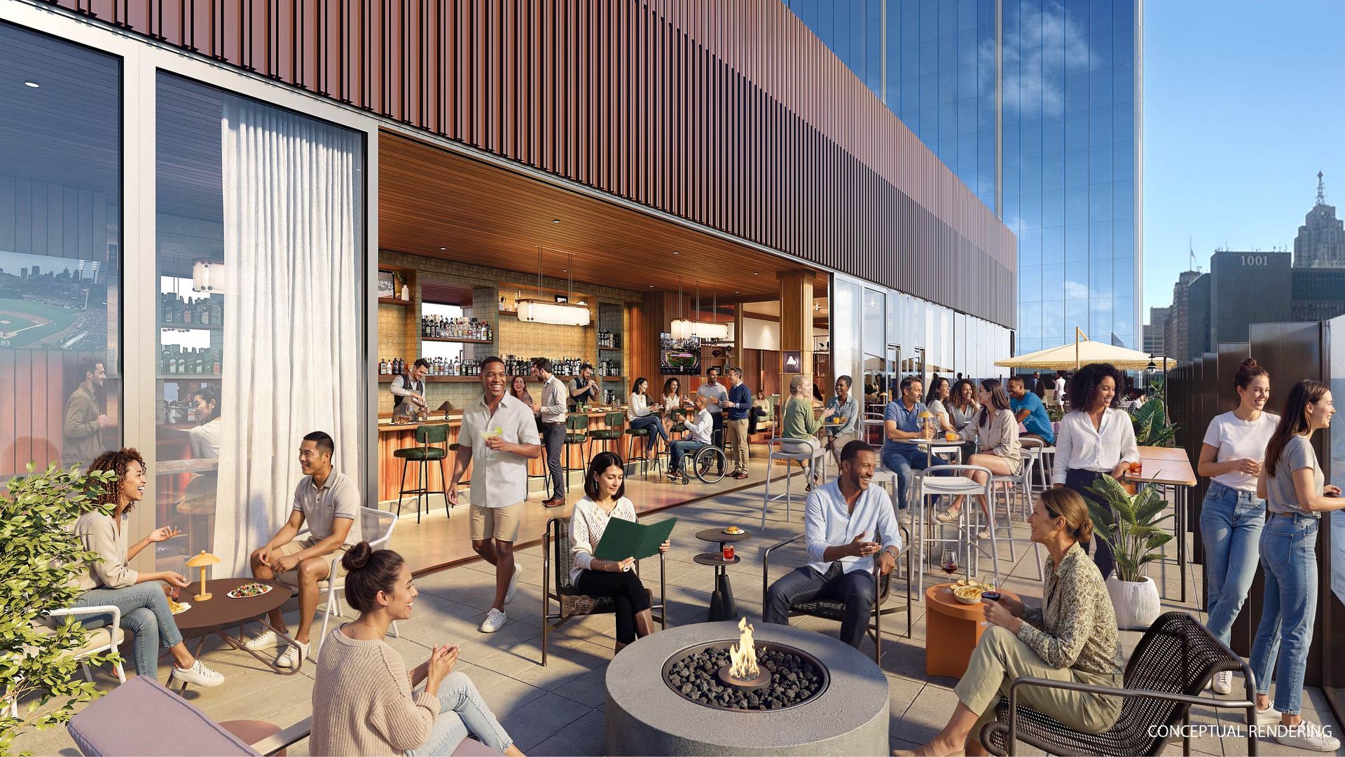 People relaxing on a rooftop patio with a fire pit, bar and city skyline in the background. 