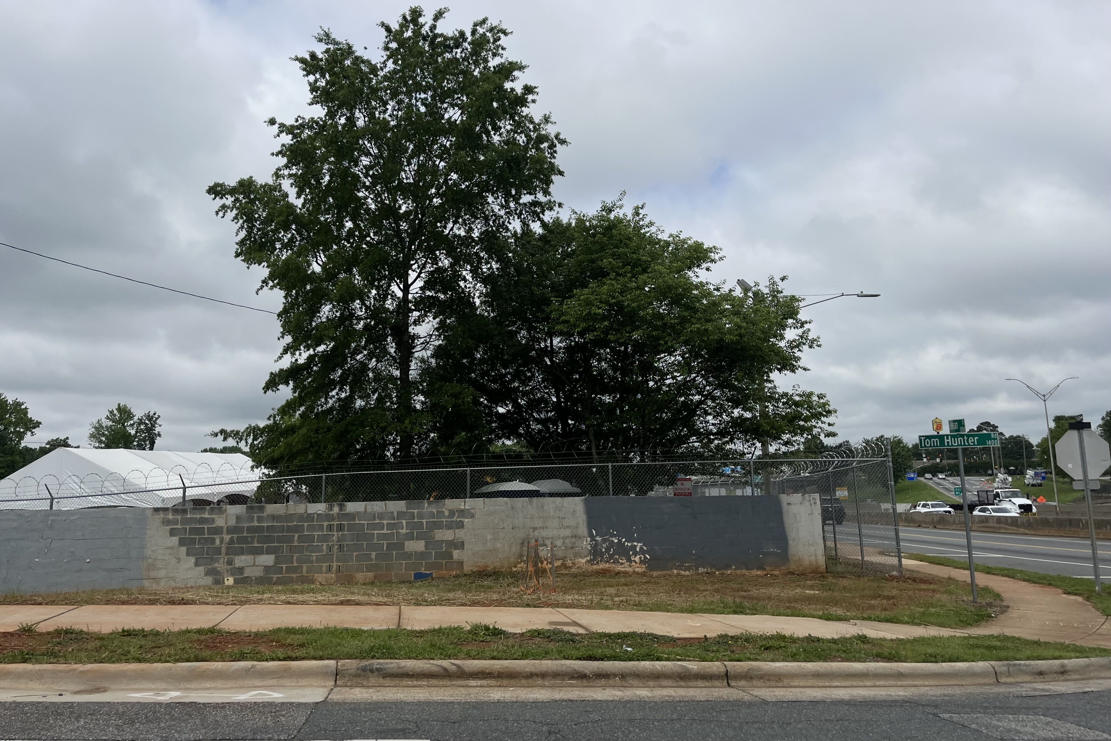 The corner of a property with a street sign