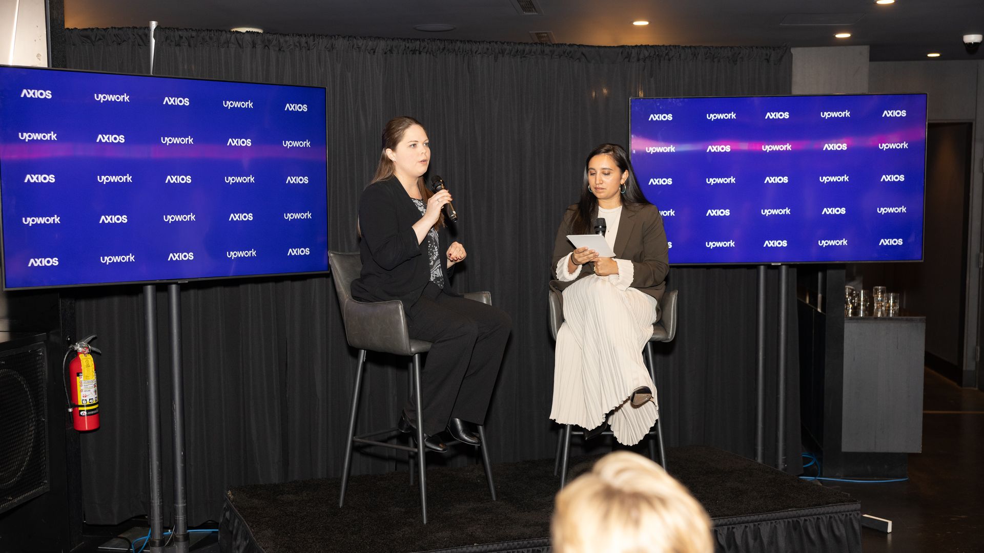Rebecca Hinds onstage with Axios' Erica Pandey.