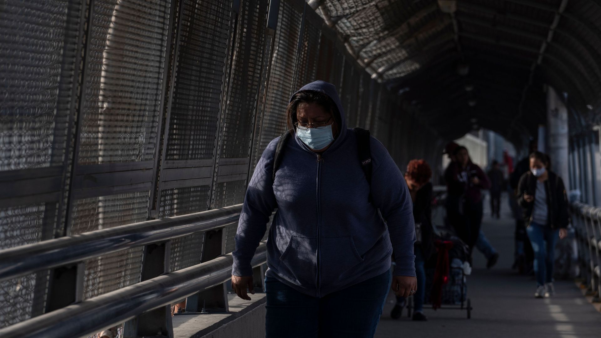 A border crosser wears a mask for protection against COVID-19 on April 1, 2020