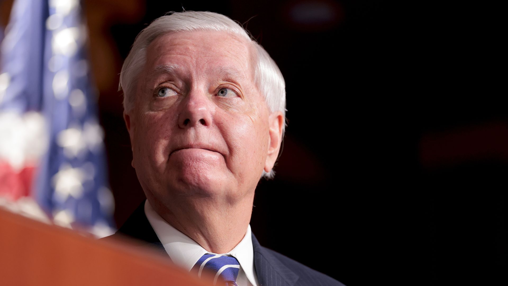 Sen. Lindsey Graham speaks at a podium during a news conference at the U.S. Capitol about legislation to fund construction of a White House ballroom.