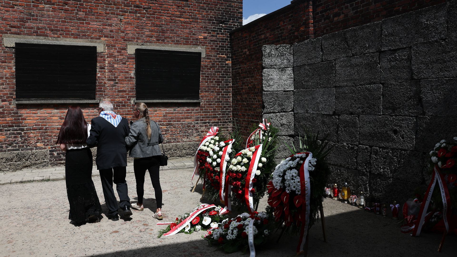 A Holocaust survivor walks near "the Death Wall" during the ceremony to mark the 85th anniversary of the first transport of Poles to Auschwitz-Bikenau in Oswiecim, Poland. Photo: Jakub Porzycki/NurPhoto via Getty Images