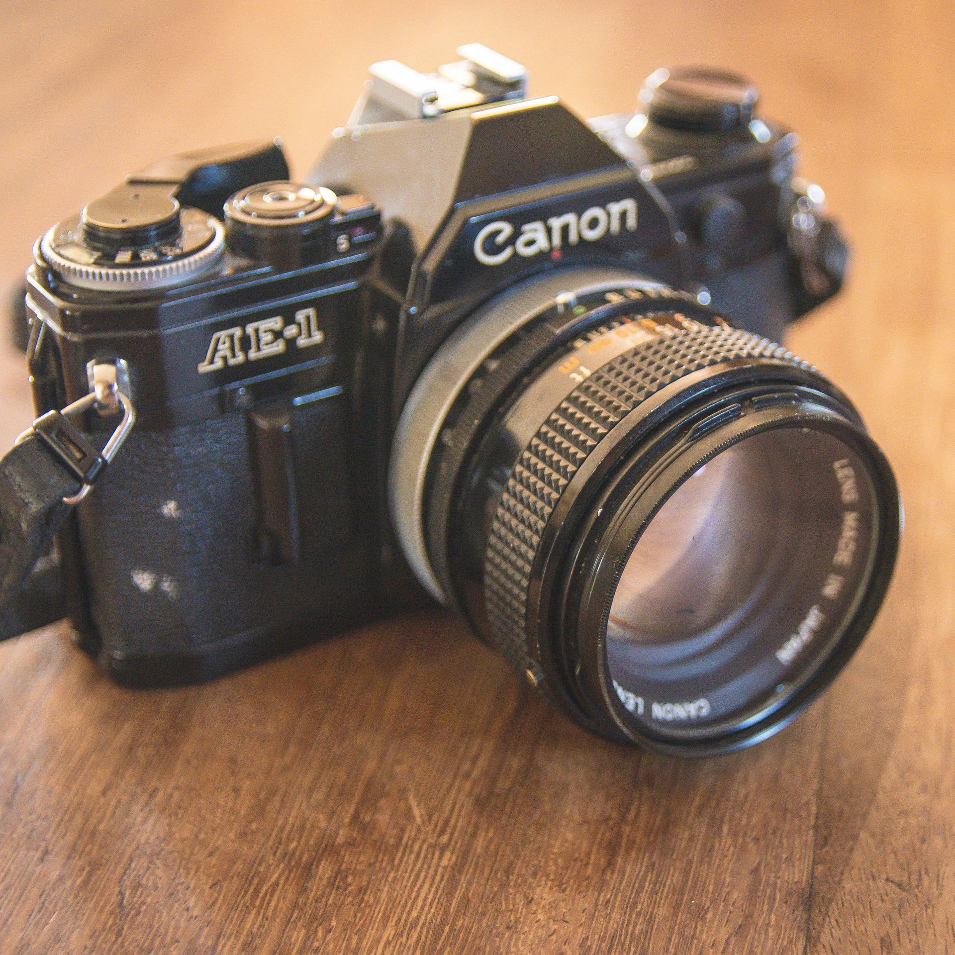 AA displayed Canon AE-1 35mm film camera.
