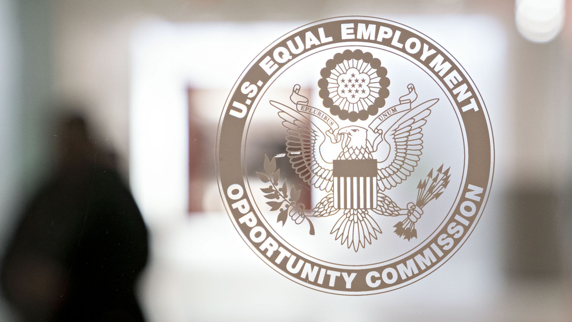 The Equal Employment Opportunity Commission (EEOC) seal is displayed on a window at the headquarters in Washington, D.C