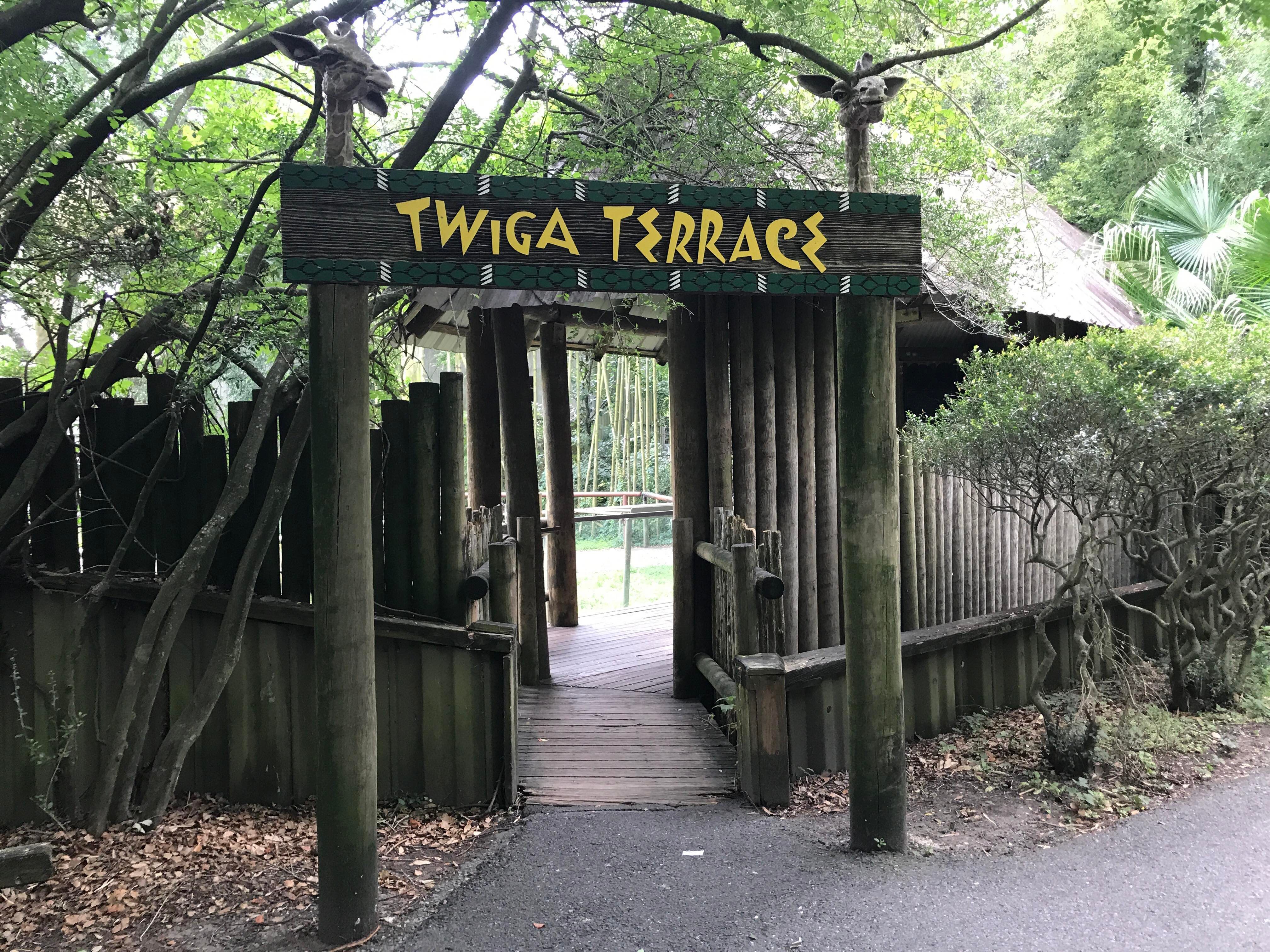 Photo shows the entrance to the giraffe habitat at Audubon Zoo. A sign says "Twiga Terrace."