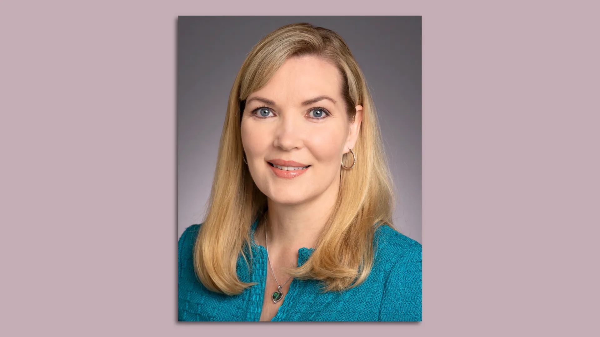 A head shot photo of Nicole Mitchell wearing a teal shirt 