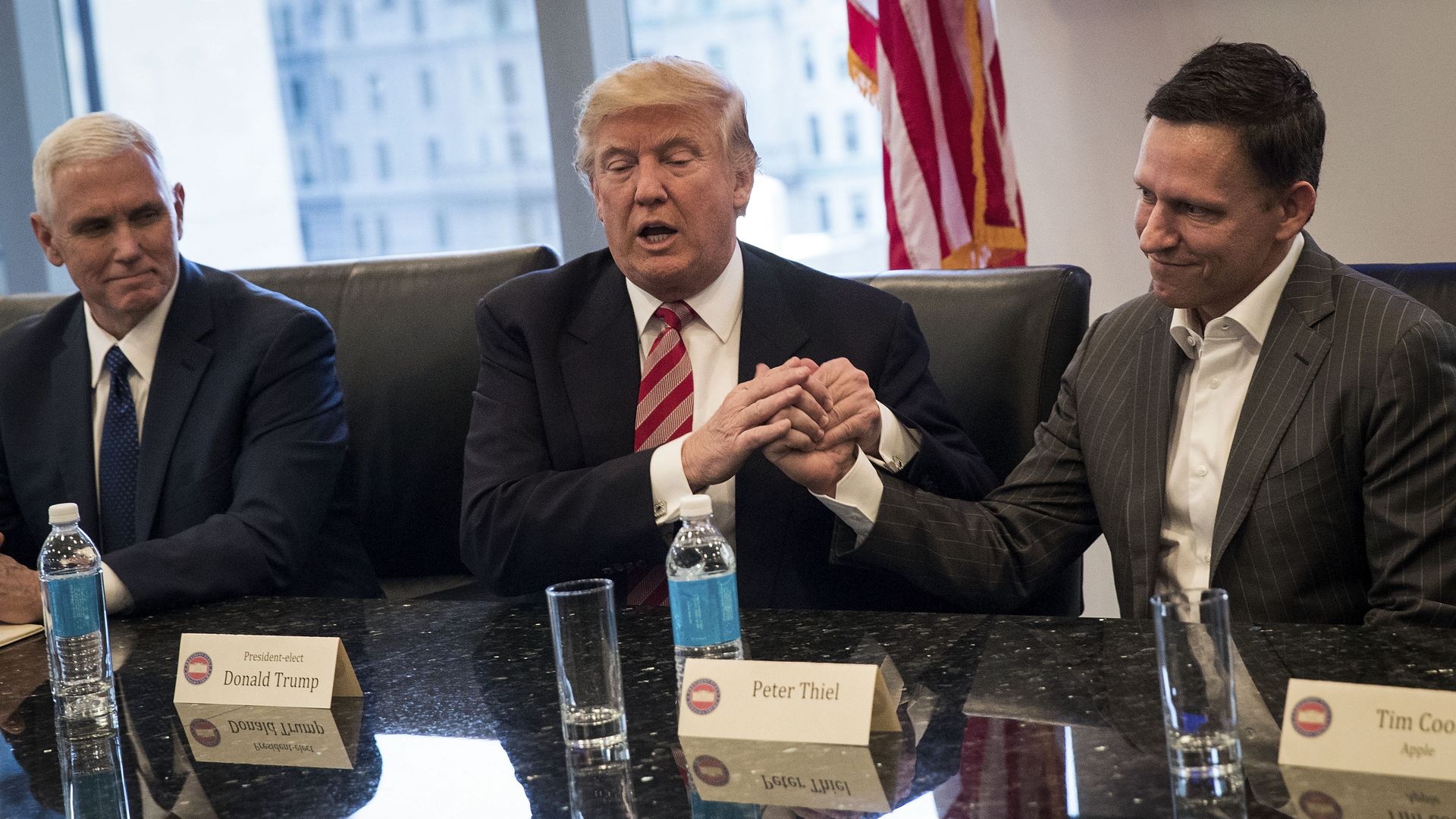 Donald Trump shakes Peter Thiel hands before taking office at Trump Tower in December 2016.
