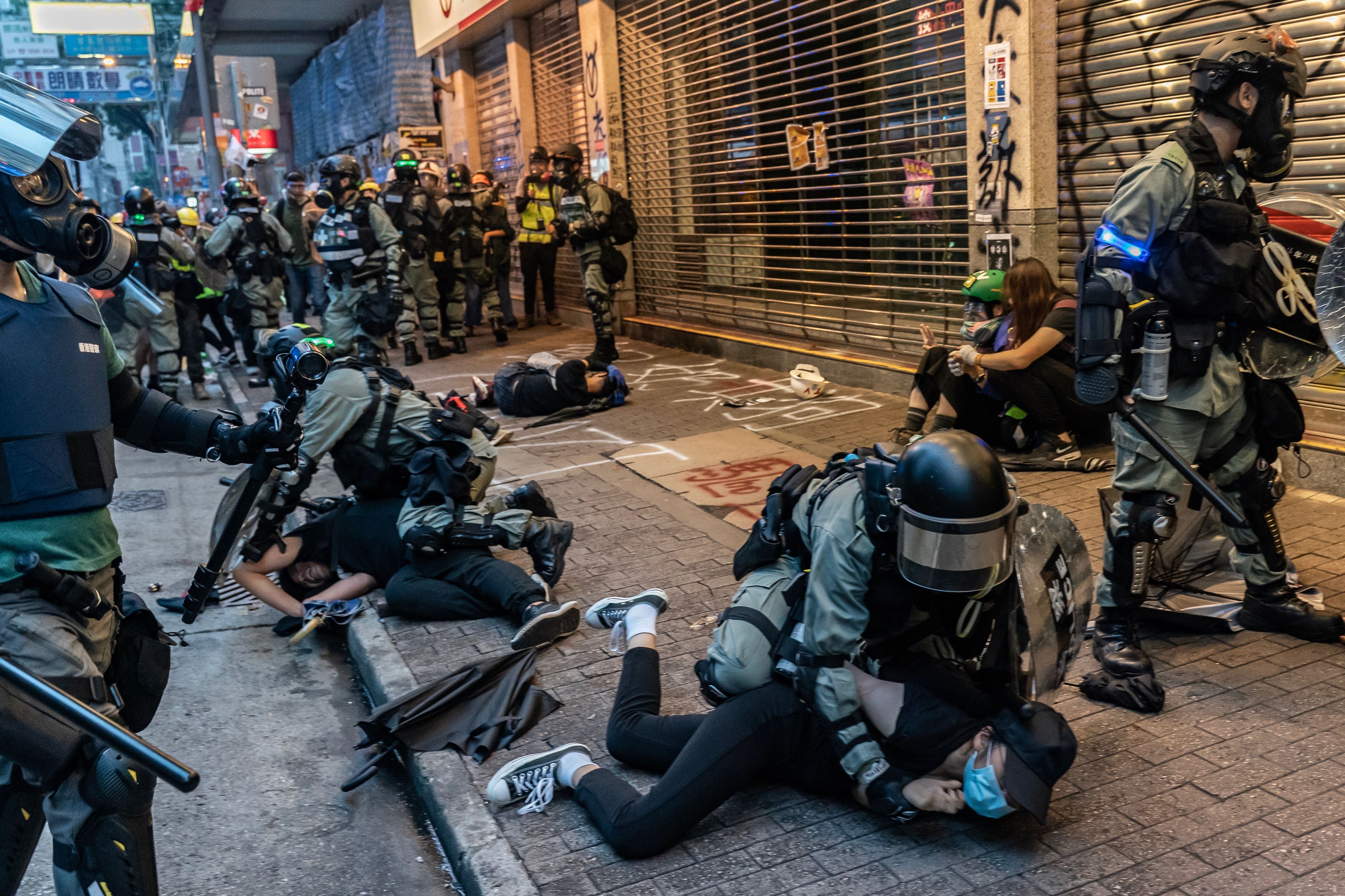 Pro-democracy protesters are arrested by police during a clash at a demonstration in Wan Chai district