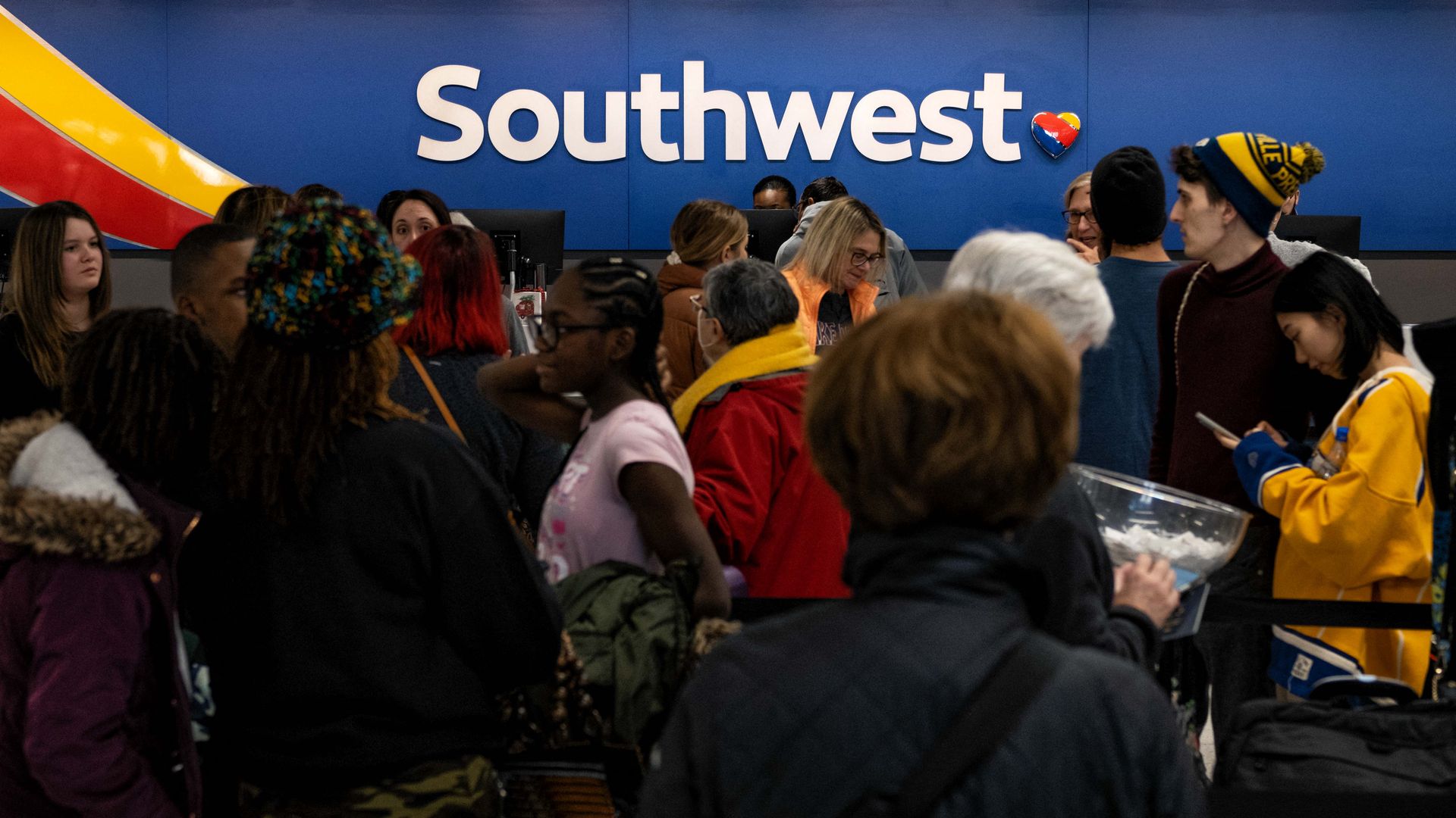 A crowd of passengers by a Southwest ticket gate