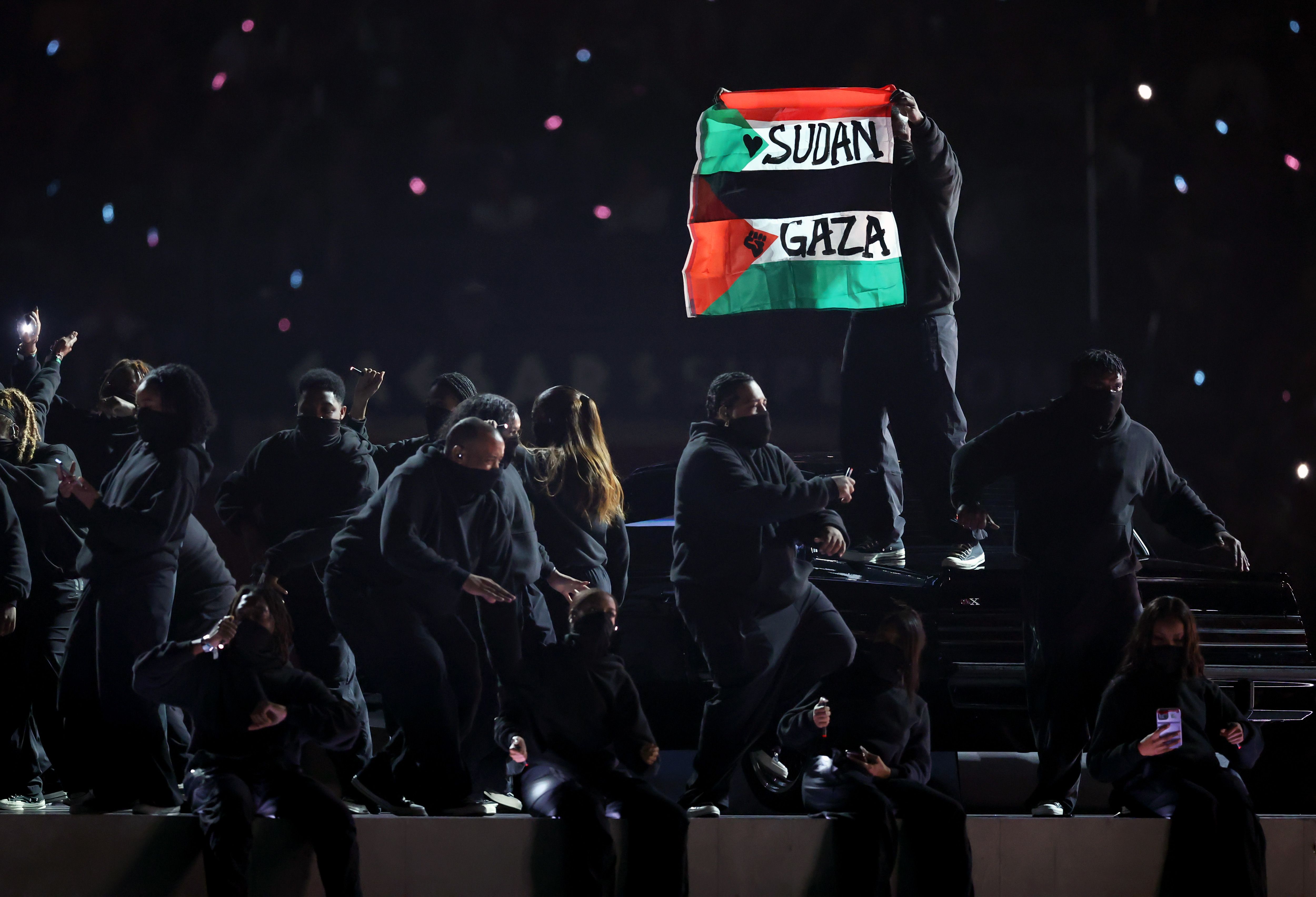 Photo shows a protester holding a flag with Gaza on it.