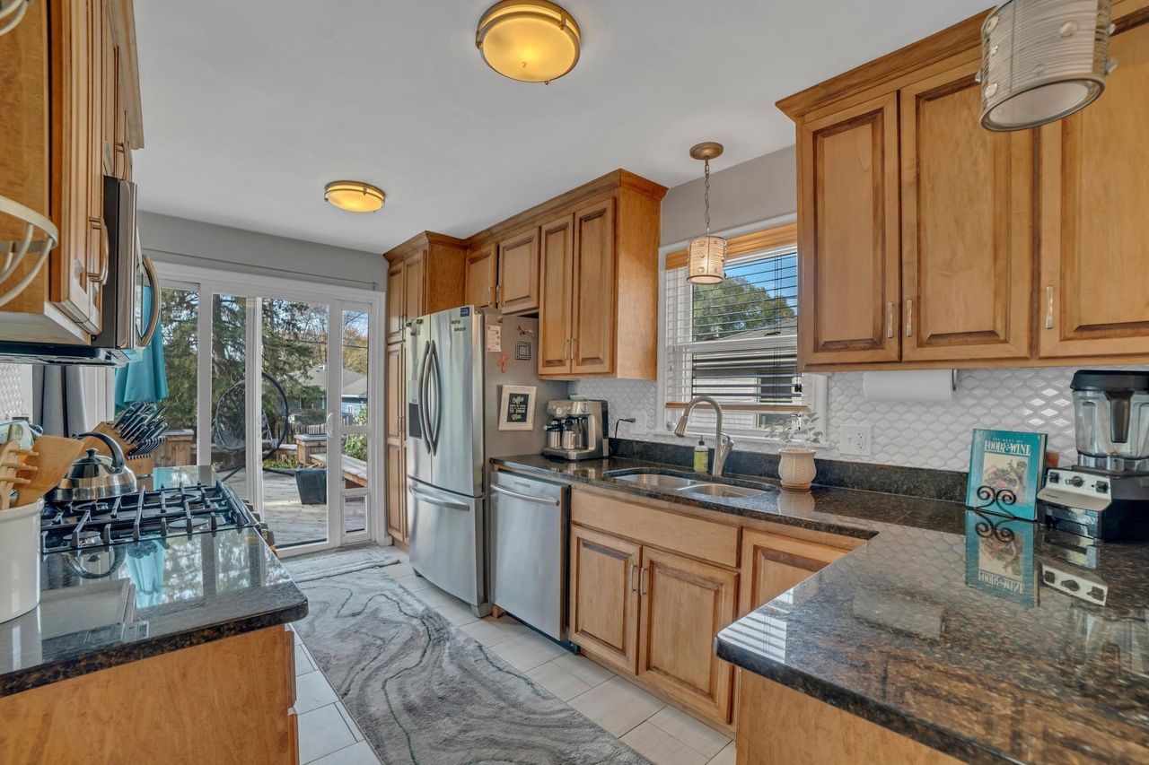 updated kitchen with doors that open to backyard