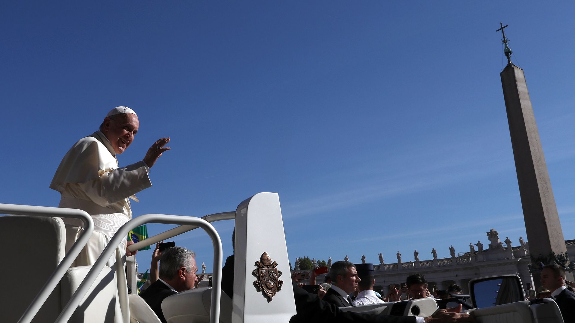 Pope Francis waving to a crowd.