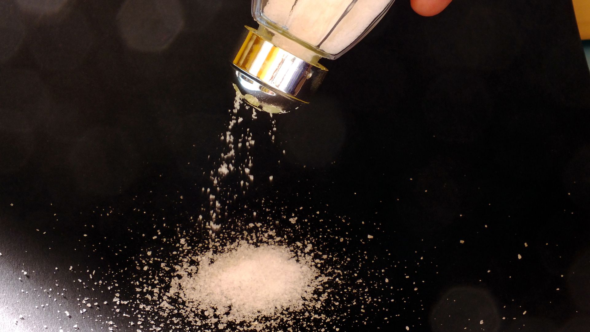 Picture of a hand holding a salt shaker