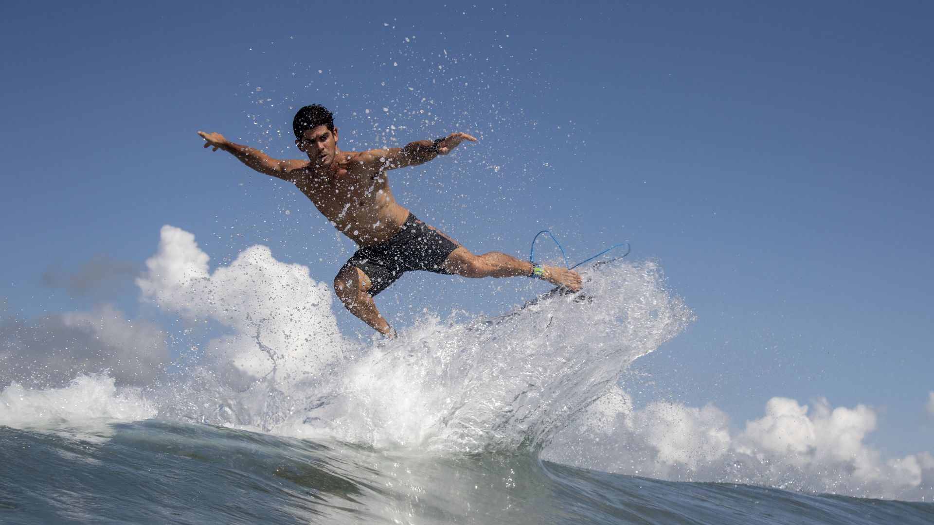 Chile's Manuel Selman rides a wave during a free training session at the Games at Tsurigasaki beach.