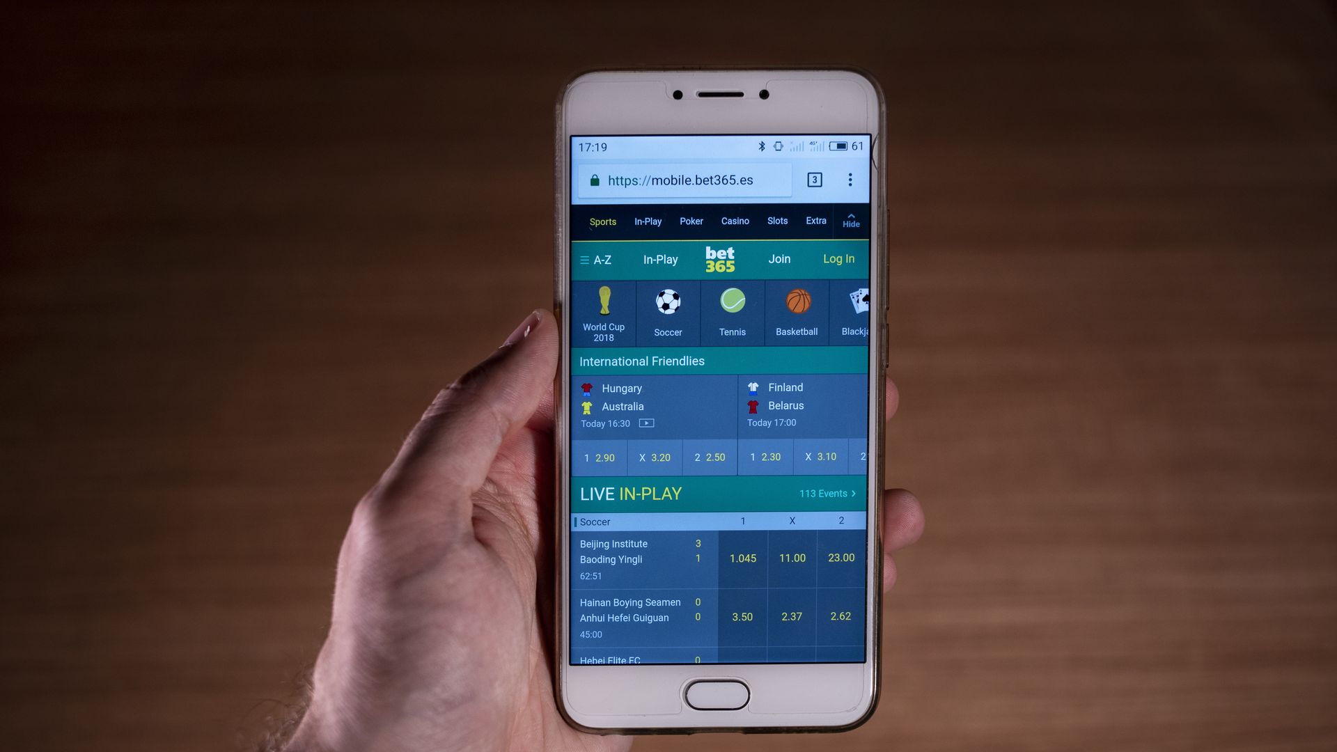 A person betting on their phone