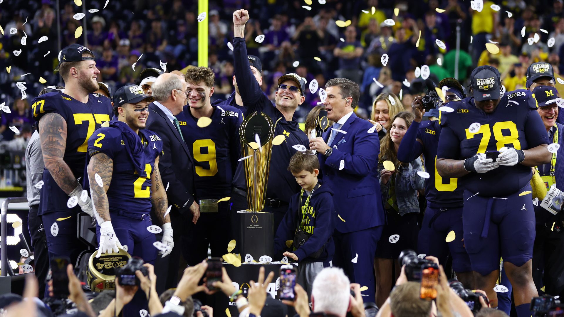 Head coach Jim Harbaugh of the Michigan Wolverines and his team celebrate after defeating the Washington Huskies during the 2024 CFP National Championship game at NRG Stadium