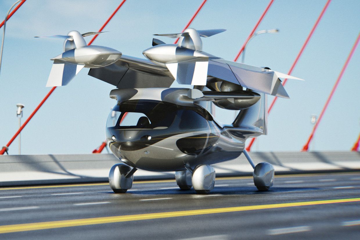 A computer rendering shows a VTOL, or vertical takeoff and landing, vehicle, docked on a bridge. Wings with rotors are folded above a car-sized vehicle resembling a modern commercial helicopter.