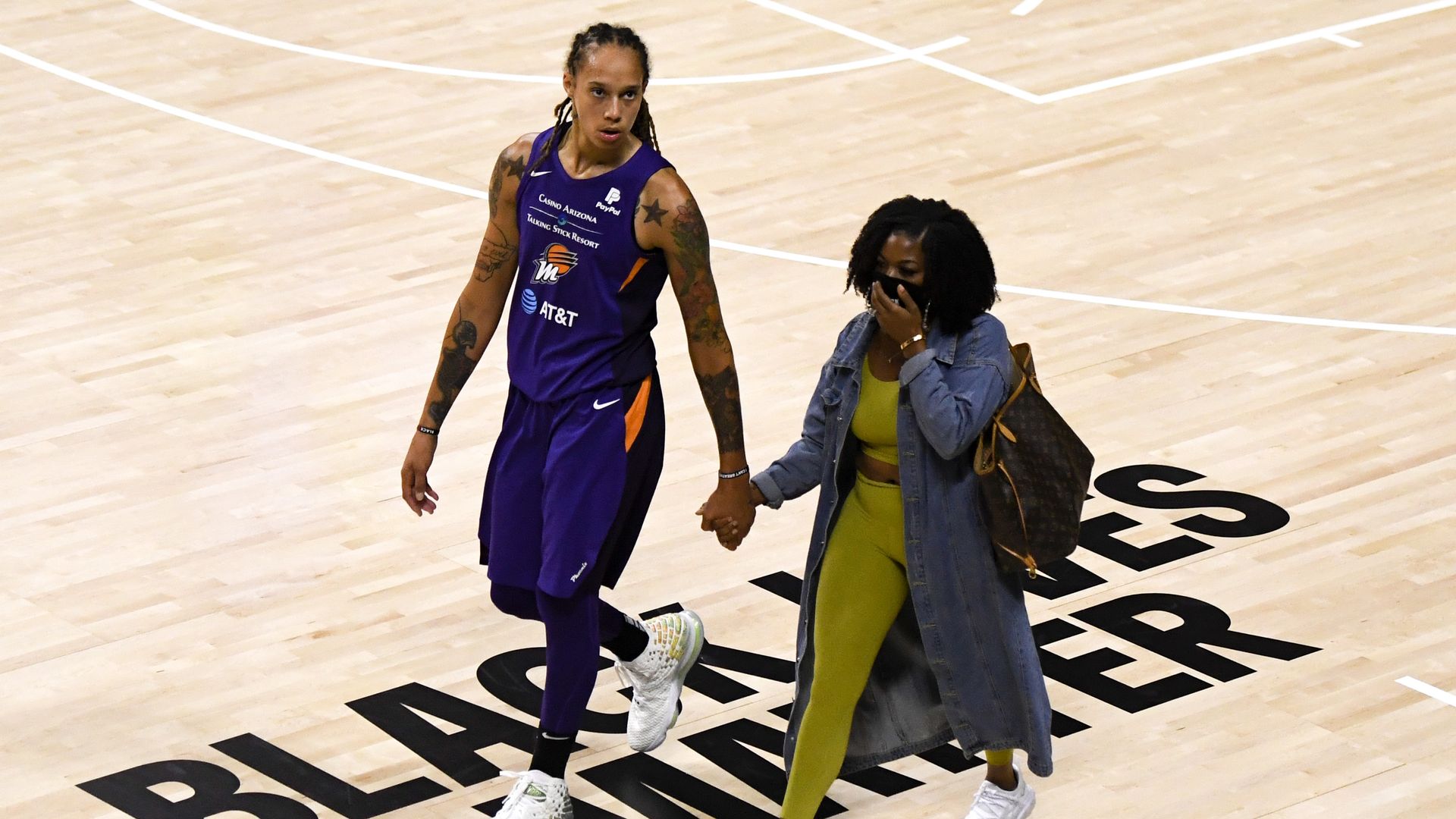 Brittney Griner #42 of the Phoenix Mercury walks hand and hand with wife Cherelle Griner.