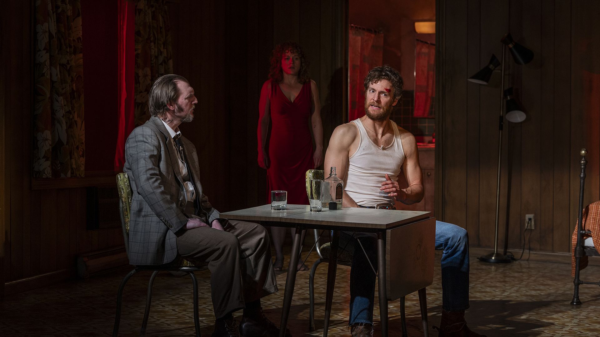 Photo of actors doing a scene from a play on a stage
