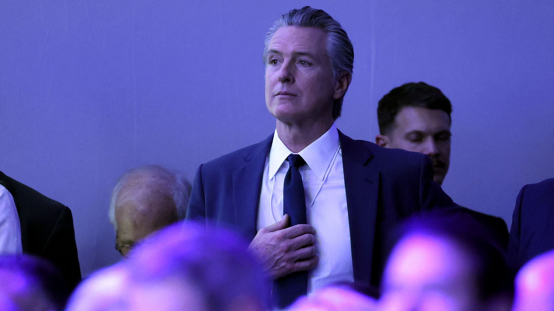 California Gov. Gavin Newsom watches President Trump deliver a speech at the World Economic Forum in Davos, Switzerland, on Jan. 21, 2026.