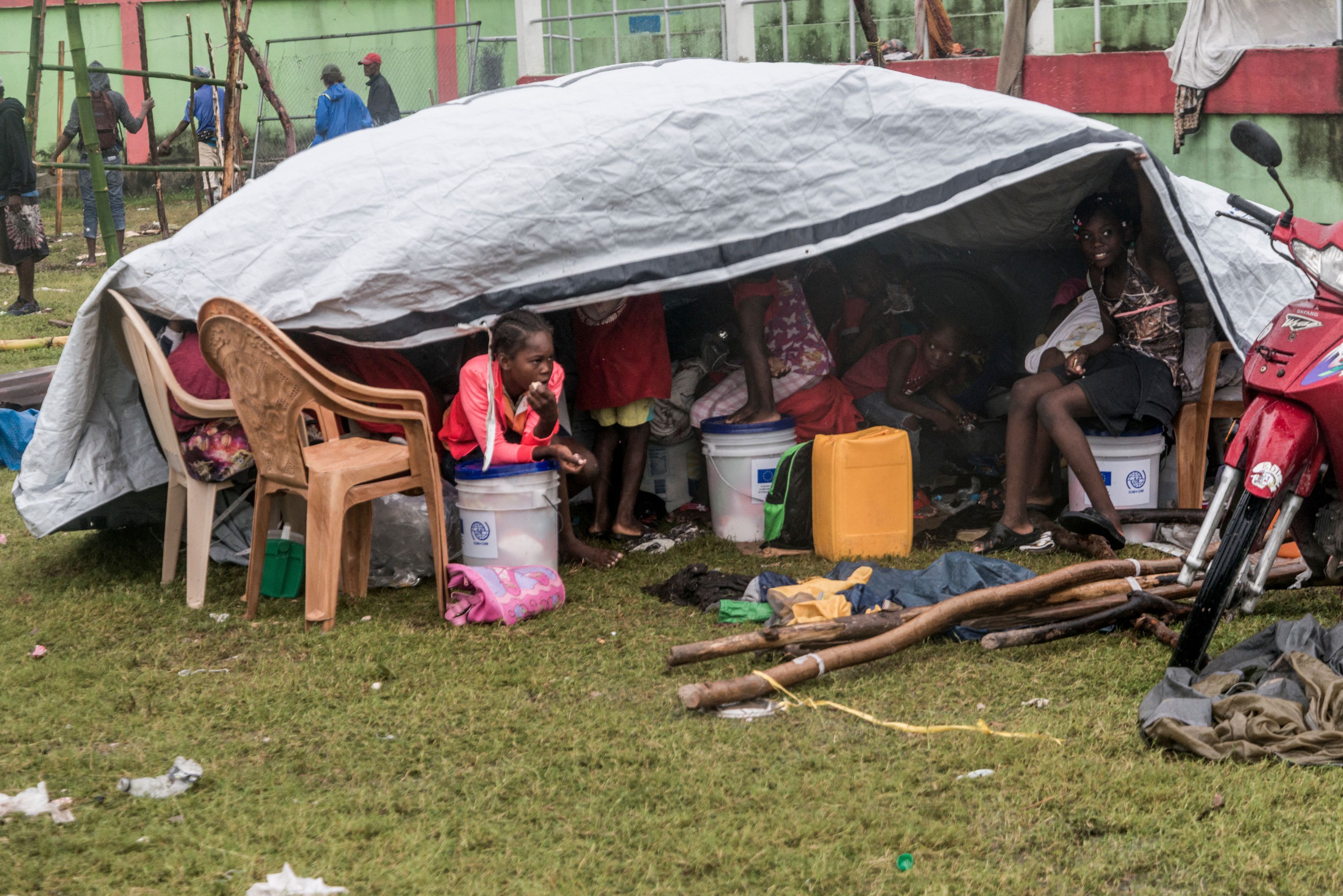 People make repairs and create shelter, after spending the night outside in the aftermath of the earthquak
