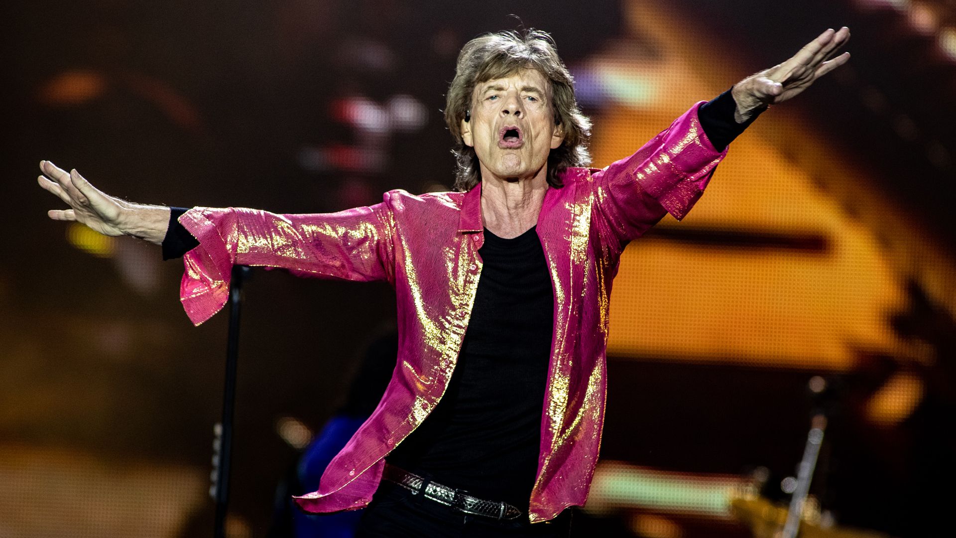 Mick Jagger dances on stage.