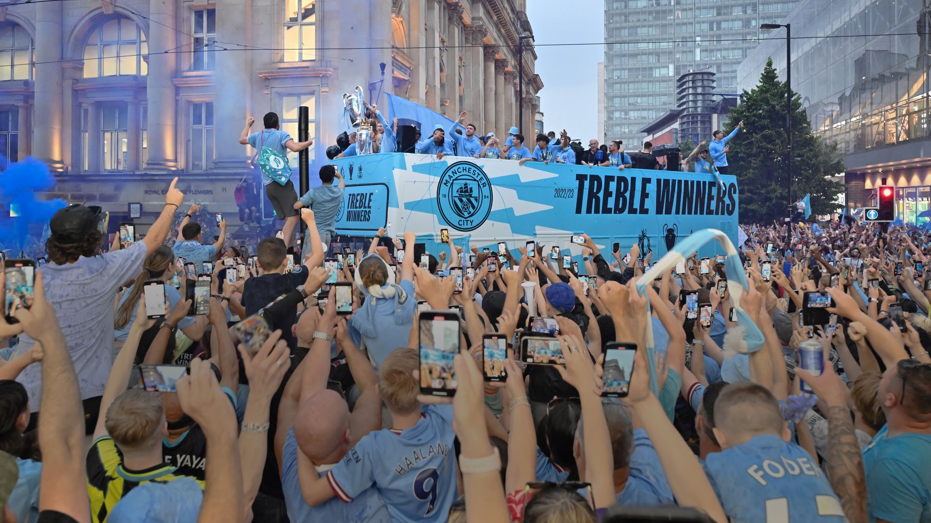 man city fans celebrate at parade
