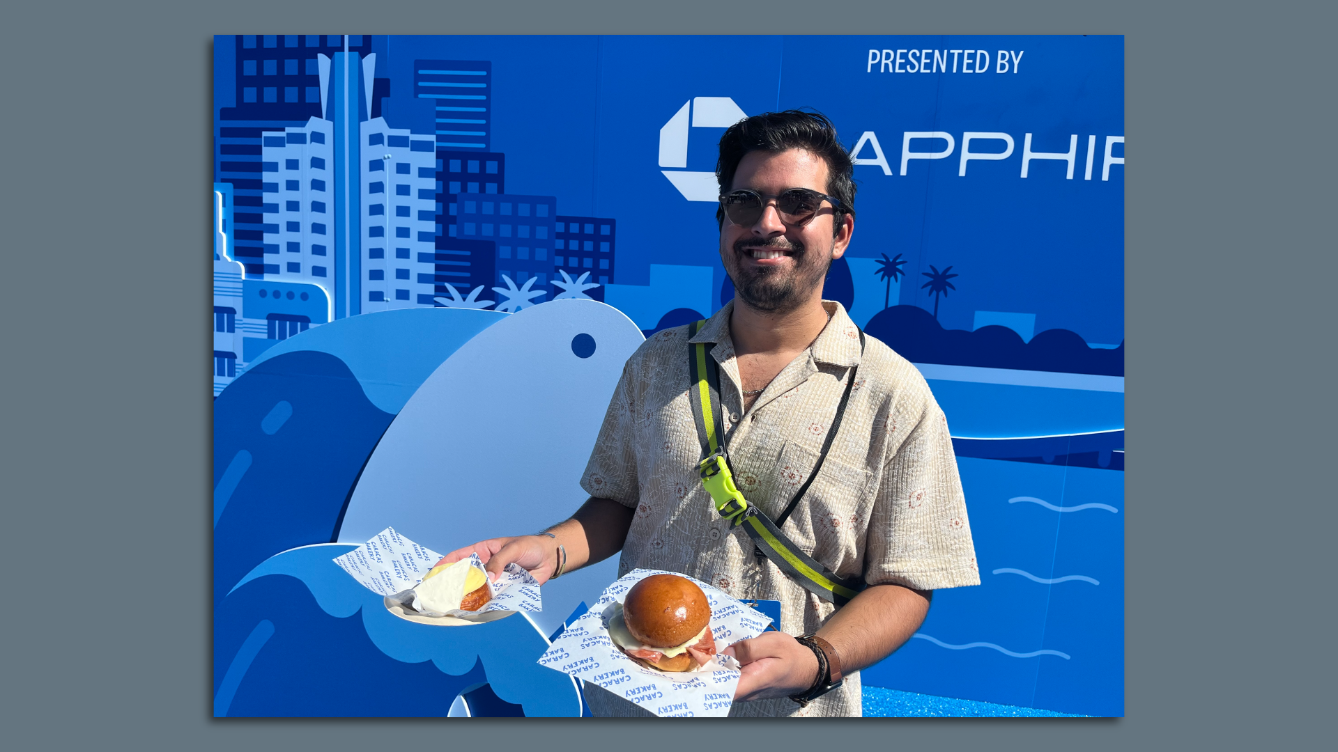 Reporter Martin Vassolo poses with plates of food at EEEEEATSCON Miami