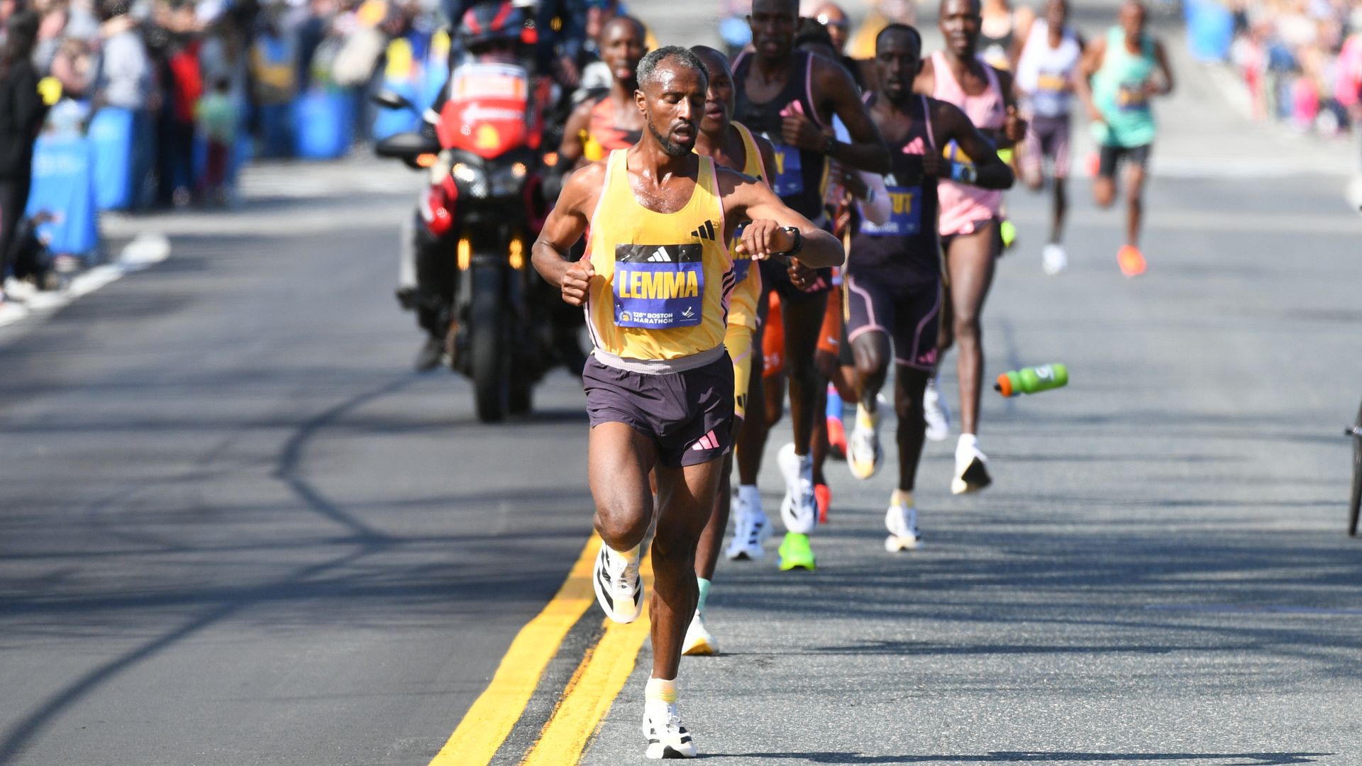 ASHLAND, MA - APRIL 15: Sisay Lemma of Ethiopia runs in the lead pack of runners of the men's division of the 128th Boston Marathon on April 15, 2024 in Ashland, MA.