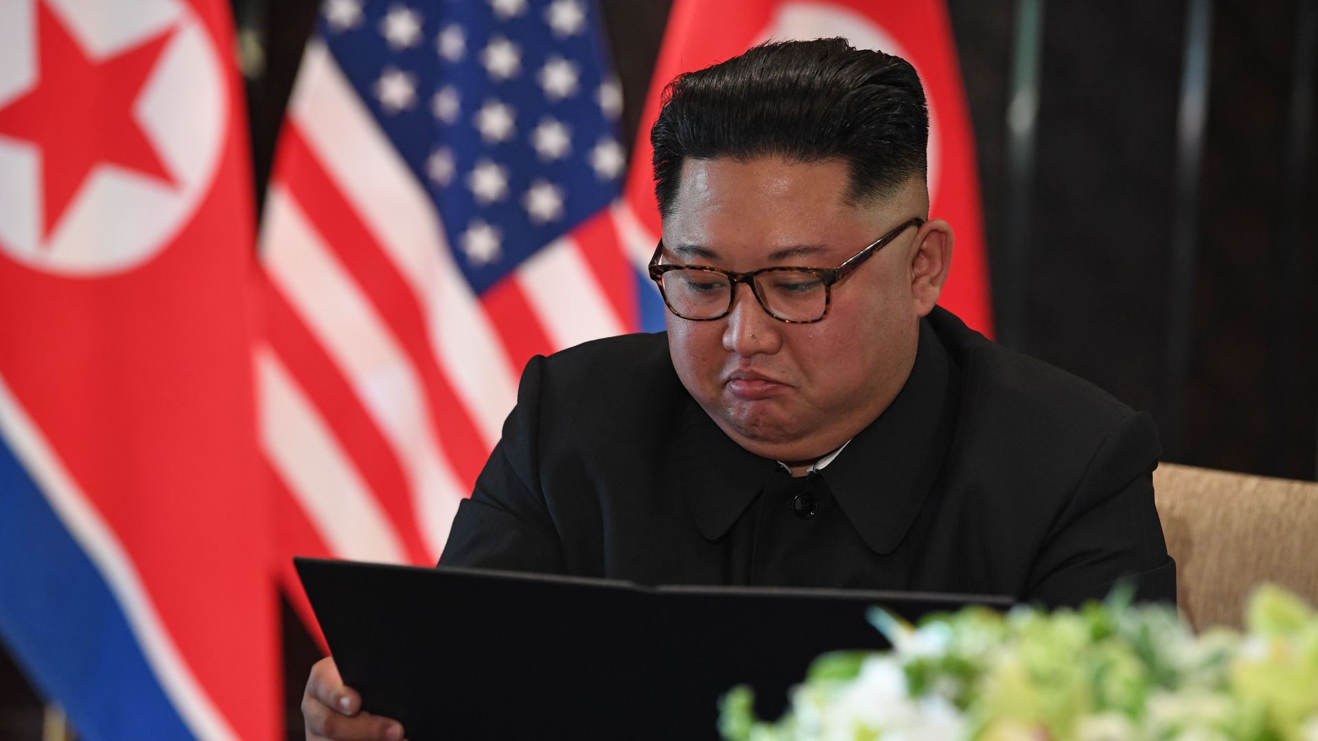 North Korea's leader Kim Jong Un looks at a signing ceremony with US President Donald Trump in Singapore on June 12, 2018.