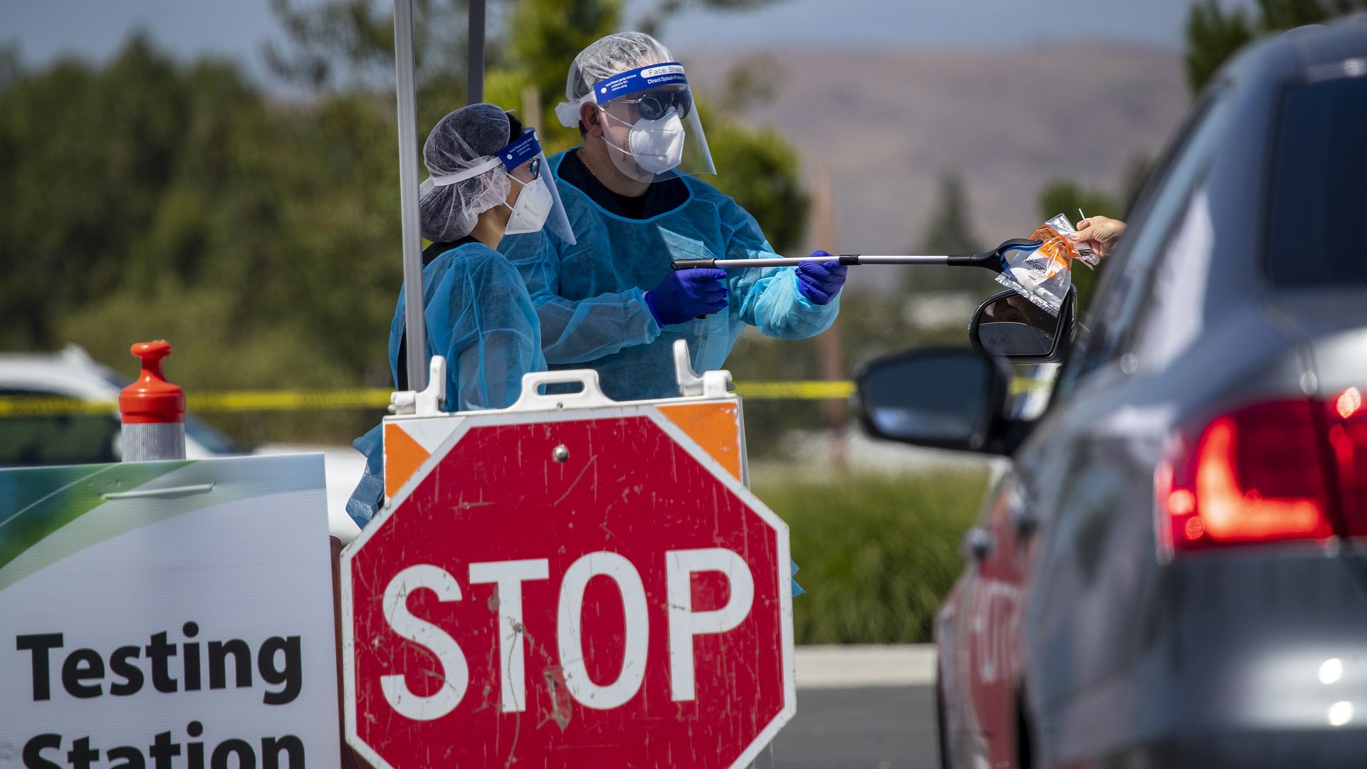 A swab test administered to someone in a car.