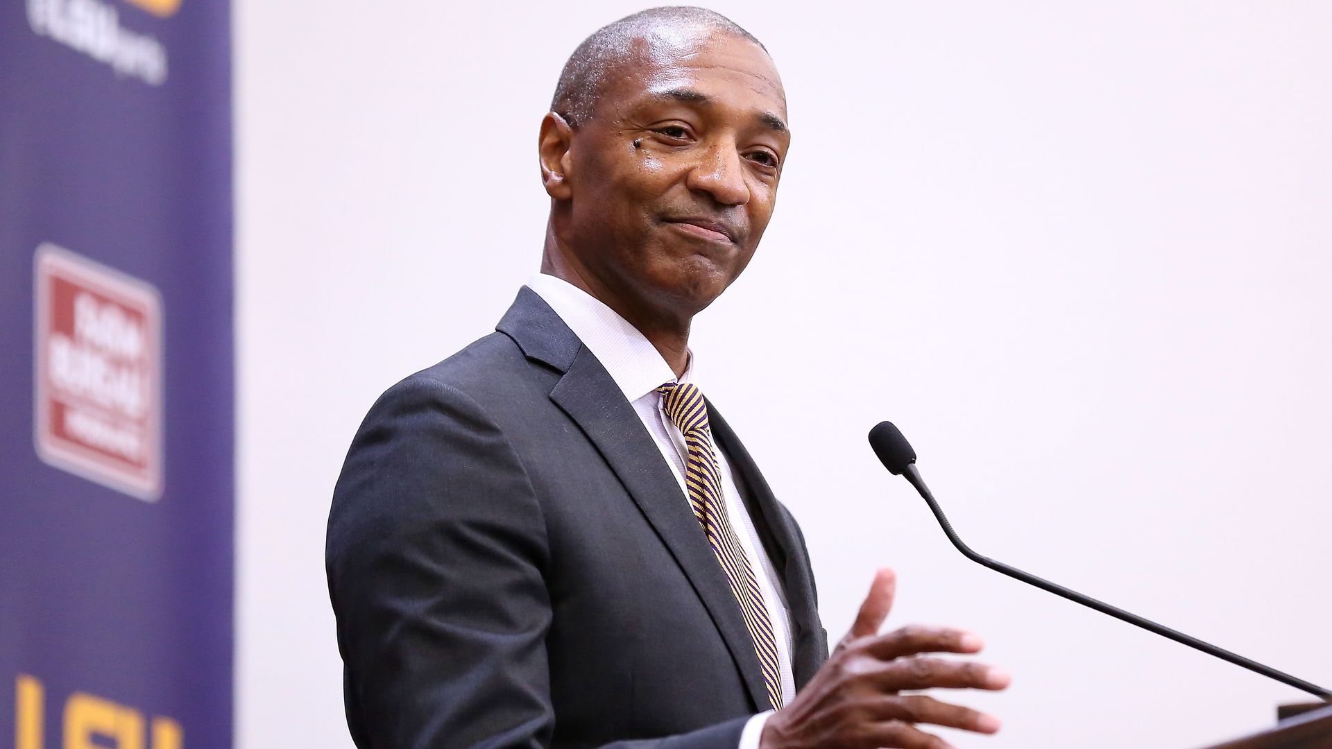 William Tate stands at a podium and speaks.