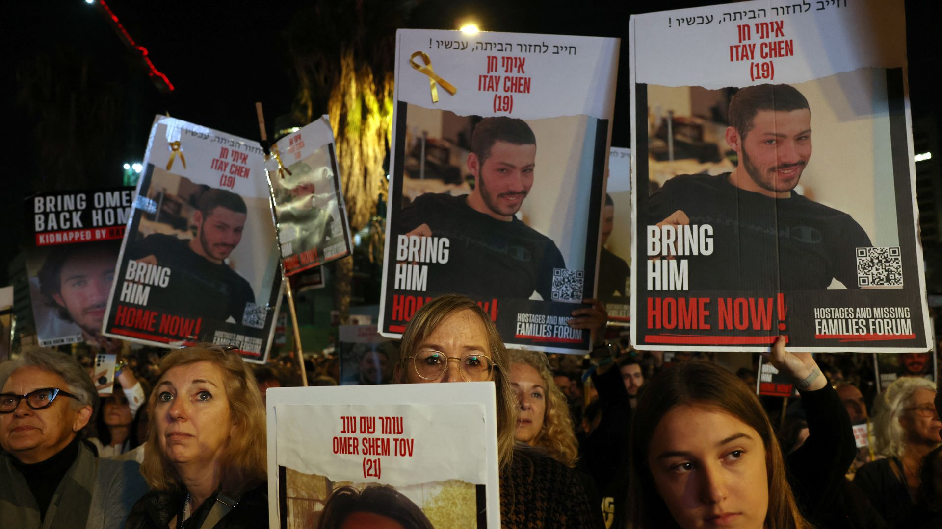 Relatives and supporters hold placards bearing portraits of Israeli hostages held in Gaza