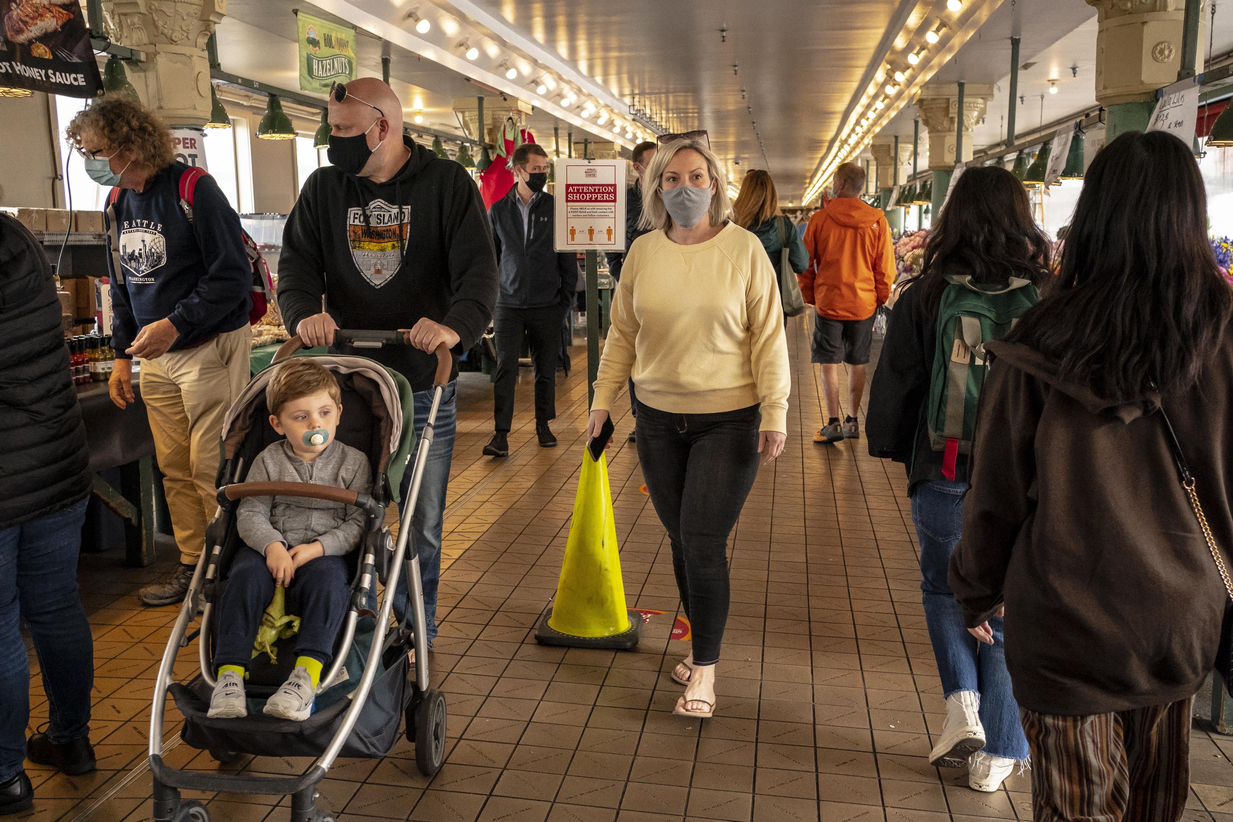  People walk through Pike Place Market as Seattle has become the first major city to reach a 70 percent COVID-19 vaccination rate on June 10, 2021 in Seattle, Washington. 