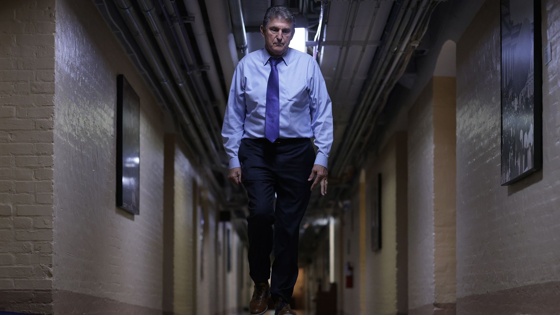 Sen. Joe Manchin is seen walking down a hall in the Capitol basement.