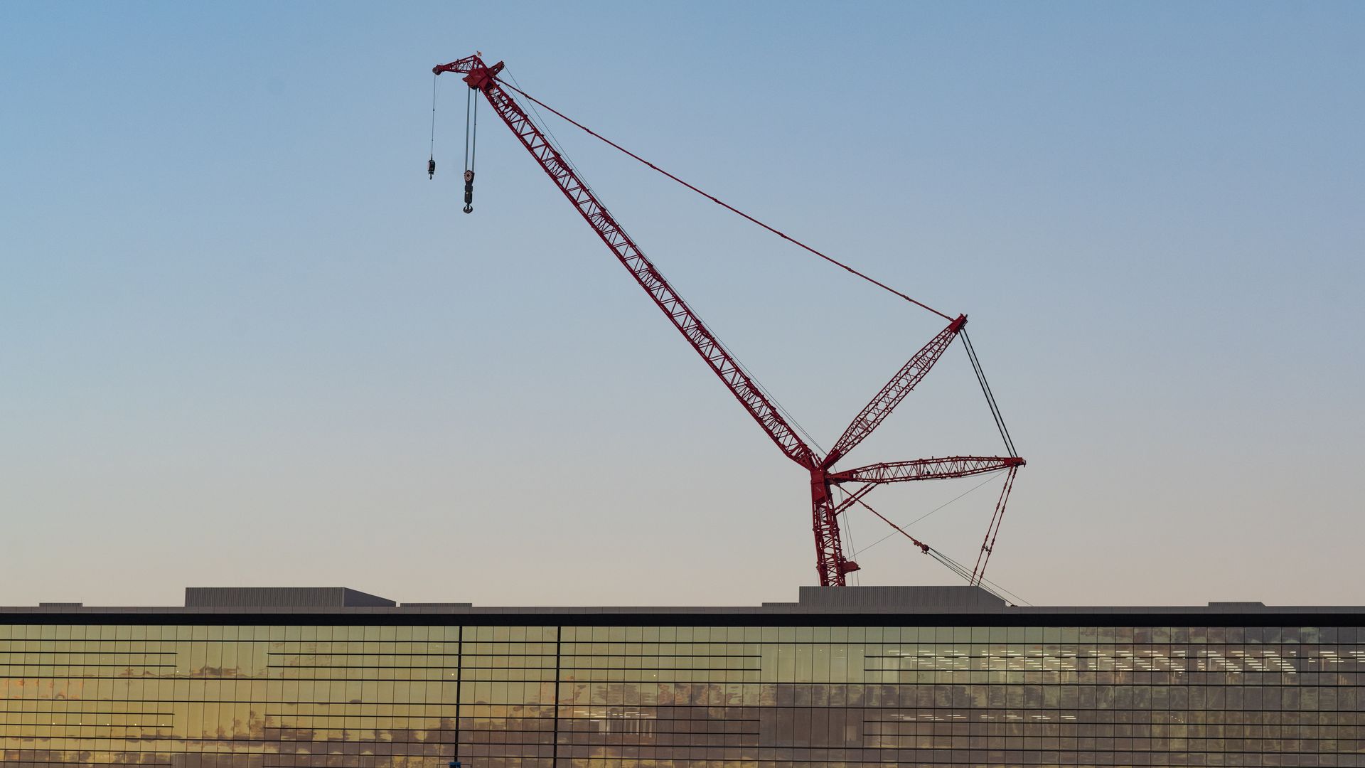 A large crane suspended above a building. 