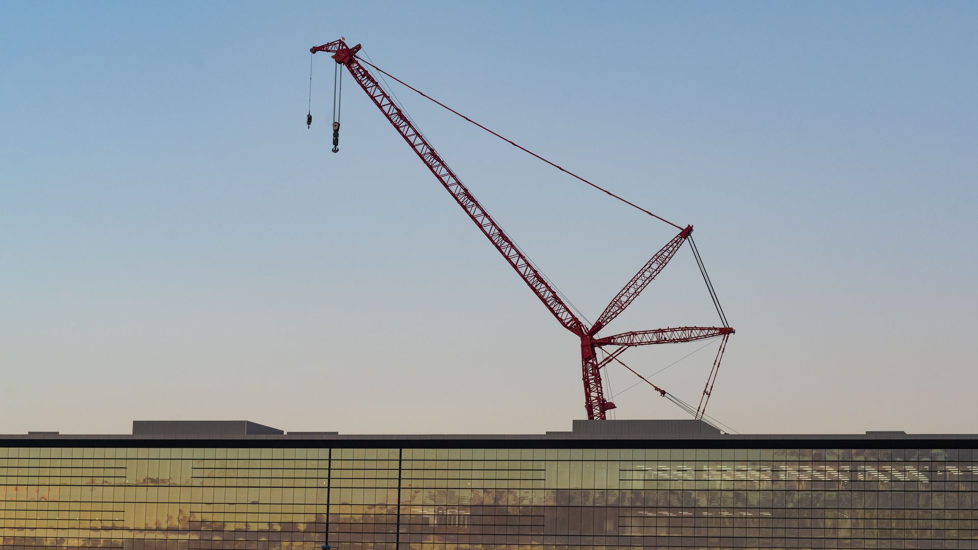 A large crane suspended above a building.