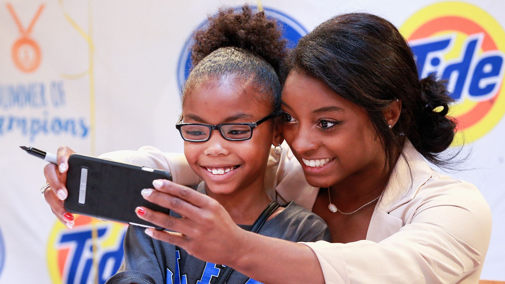 Simone Biles and a young fan