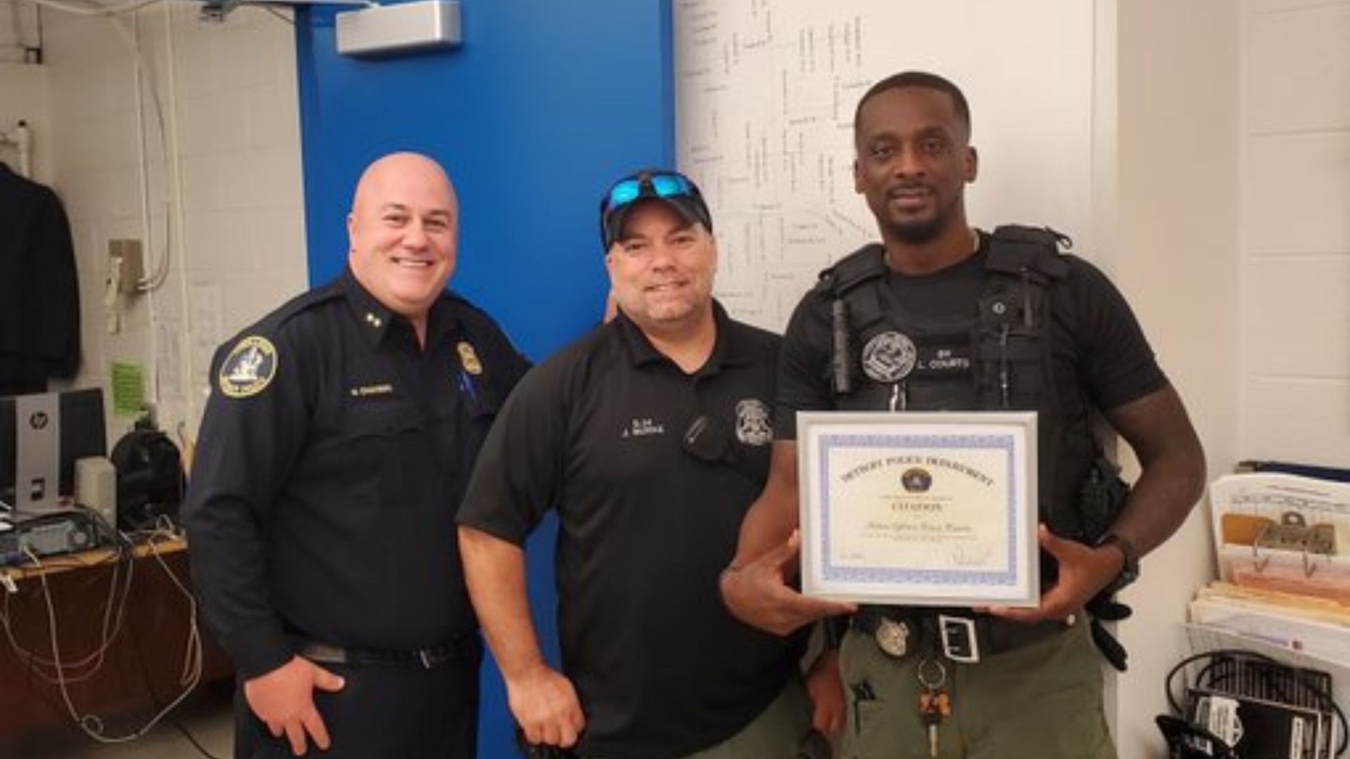 Slain Detroit police officer Loren Courts, on the far right
