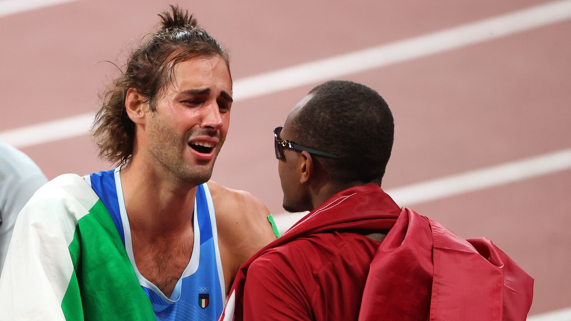 Gianmarco Tamberi of Team Italy and Mutaz Essa Barshim of Team Qatar celebrate after agreeing to share gold in the Men's High Jump Final on day nine of the Tokyo 2020 Olympic Games 