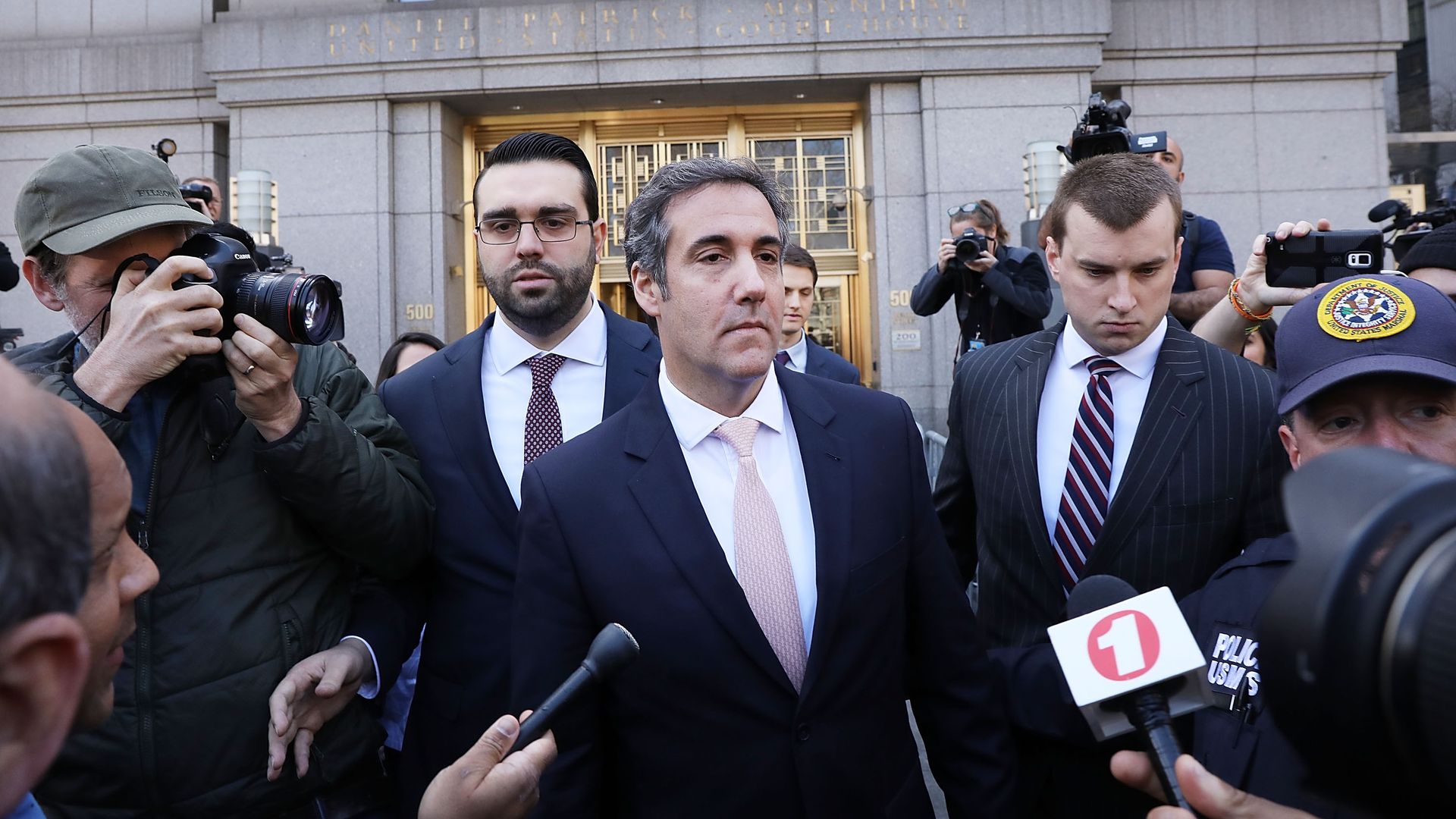 Michael Cohen surrounded by reporters. 