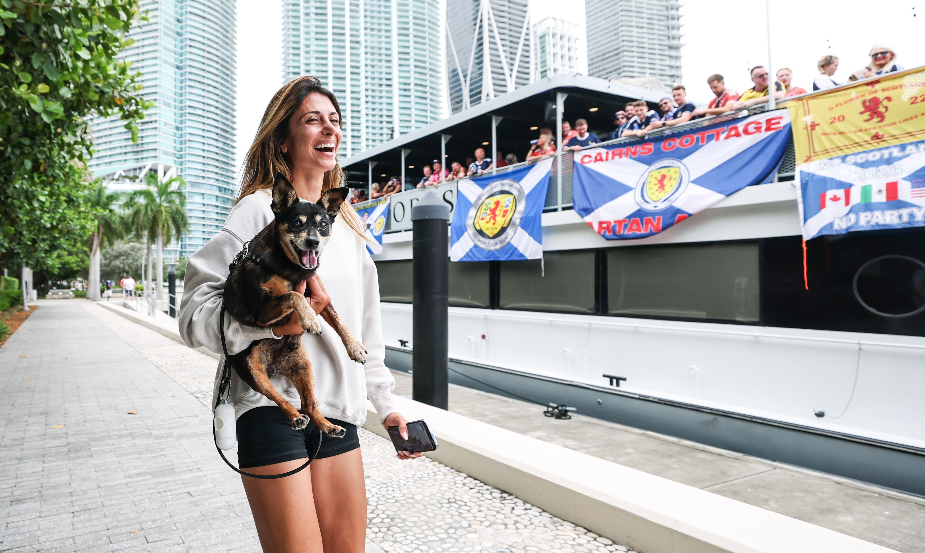 MIAMI, FLORIDA - JUNE 23: A bypasser shares a joke with Scotland fans at the North East Tartan Army boat party ahead of Wednesday's FIFA World Cup match against Brazil, on June 23, 2026, in Miami, Florida. (Photo by Craig Williamson/SNS Group via Getty Images)

