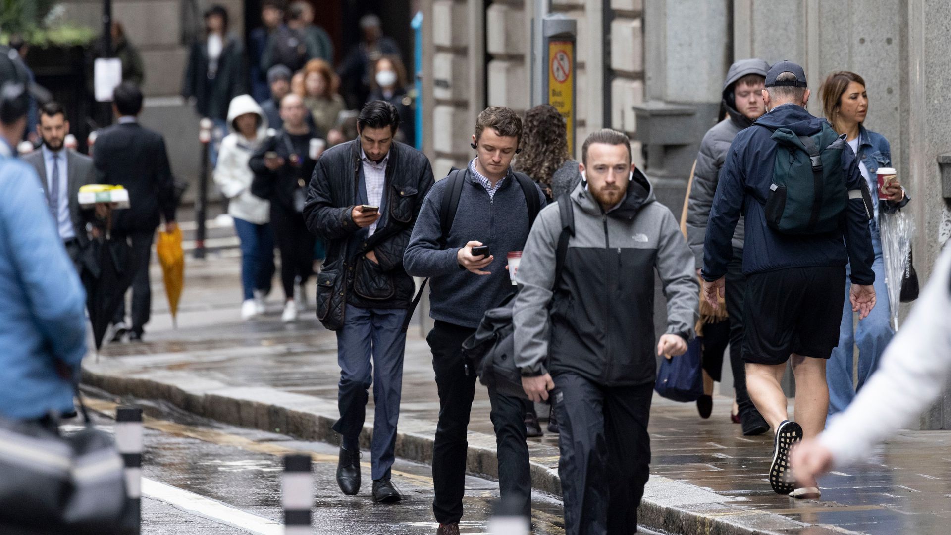 Commuters walk along a sidewalk in London, UK, on Monday, June 6, 2022.